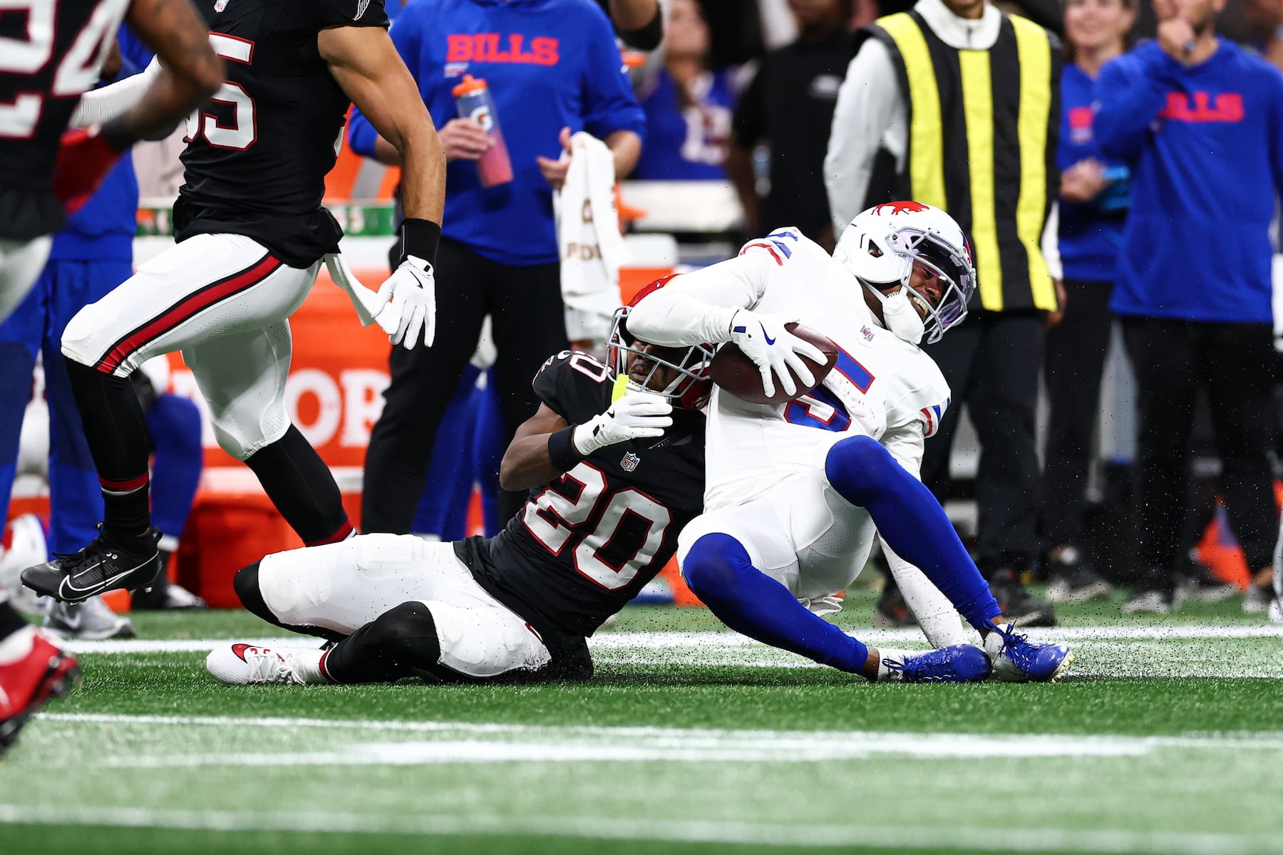 ATLANTA, GEORGIA - OCTOBER 13: Dee Alford #20 of the Atlanta Falcons tackles Josh Palmer #5 of the Buffalo Bills during the second quarter at Mercedes-Benz Stadium on October 13, 2025 in Atlanta, Georgia. (Photo by Kevin Sabitus/Getty Images)