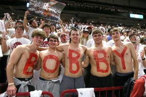 Fayetteville, Arkansas, USA; Arkansas Razorbacks students paint their chest for recently hired offensive coordinator Bobby Petrino during the game against the Duke Blue Devils at Bud Walton Arena. Arkansas won 80-75. Mandatory Credit: Nelson Chenault-USA TODAY Sports.