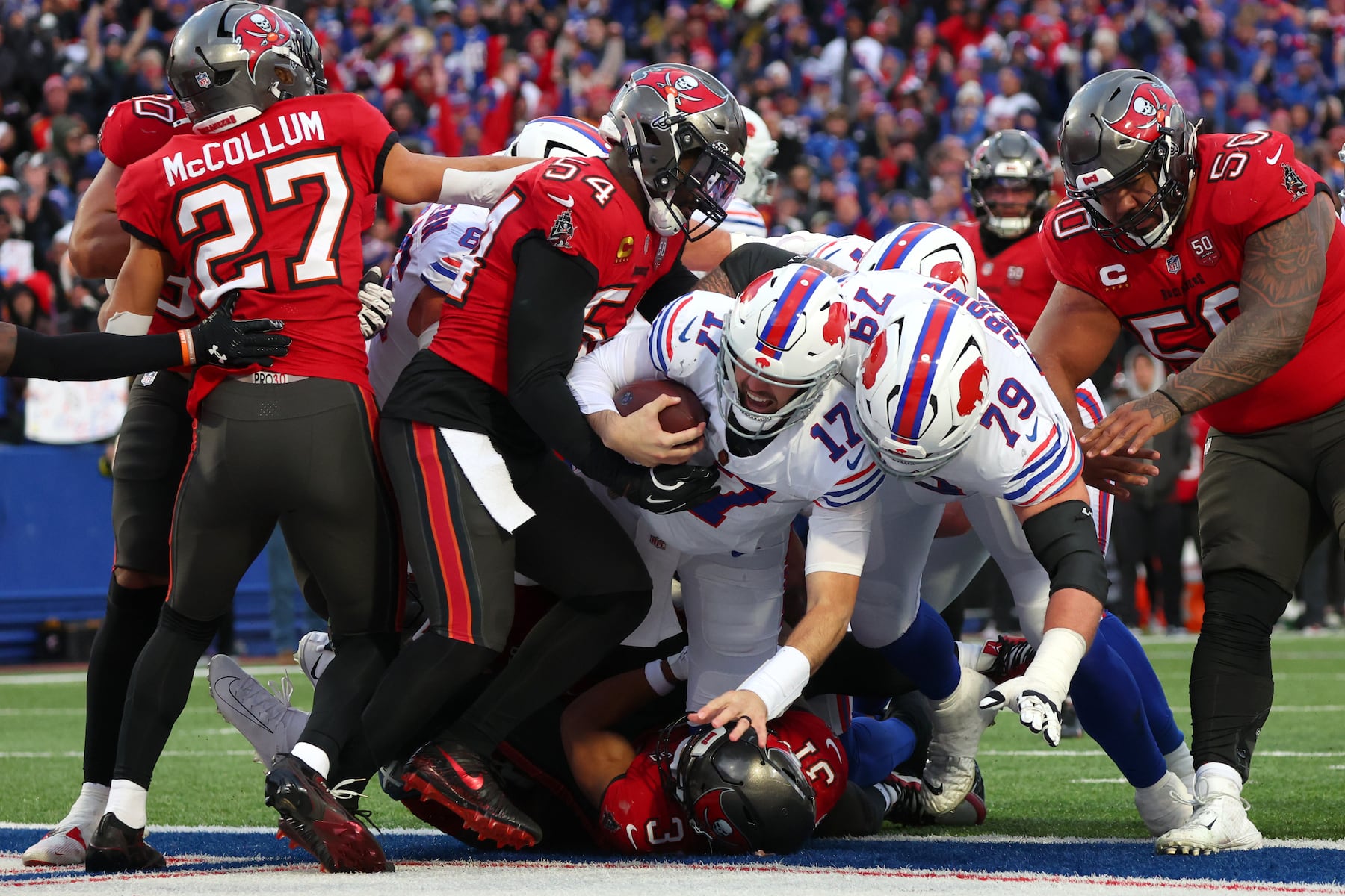 Buffalo Bills quarterback Josh Allen (17) dives for a touchdown against Tampa Bay Buccaneers linebacker Lavonte David (54) and safety Antoine Winfield Jr. (31) during the second half of an NFL football game, Sunday, Nov. 16, 2025, in Orchard Park, N.Y. (AP Photo/Jeffrey T. Barnes)