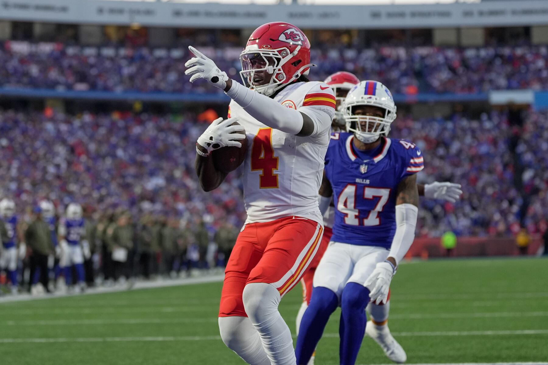 Kansas City Chiefs wide receiver Rashee Rice (4) scores past Buffalo Bills cornerback Christian Benford (47) during the first half of an NFL football game Sunday, Nov. 2, 2025, in Orchard Park. N.Y. (AP Photo/Sue Ogrocki)