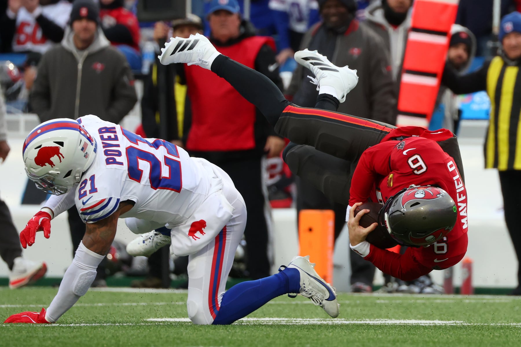 Tampa Bay Buccaneers quarterback Baker Mayfield (6) runs against Buffalo Bills safety Jordan Poyer (21) during the first half of an NFL football game, Sunday, Nov. 16, 2025, in Orchard Park, N.Y. (AP Photo/Jeffrey T. Barnes)