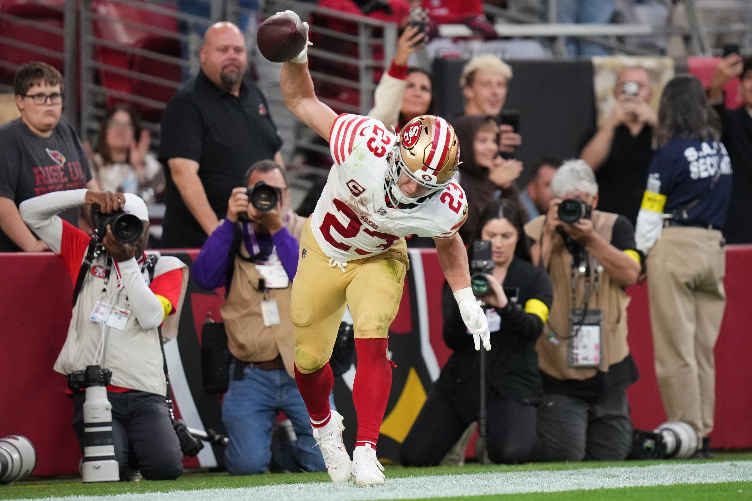 San Francisco 49ers running back Christian McCaffrey (23) spikes the ball after running in a touchdown against the Arizona Cardinals at State Farm Stadium in Glendale on Nov. 16, 2025.