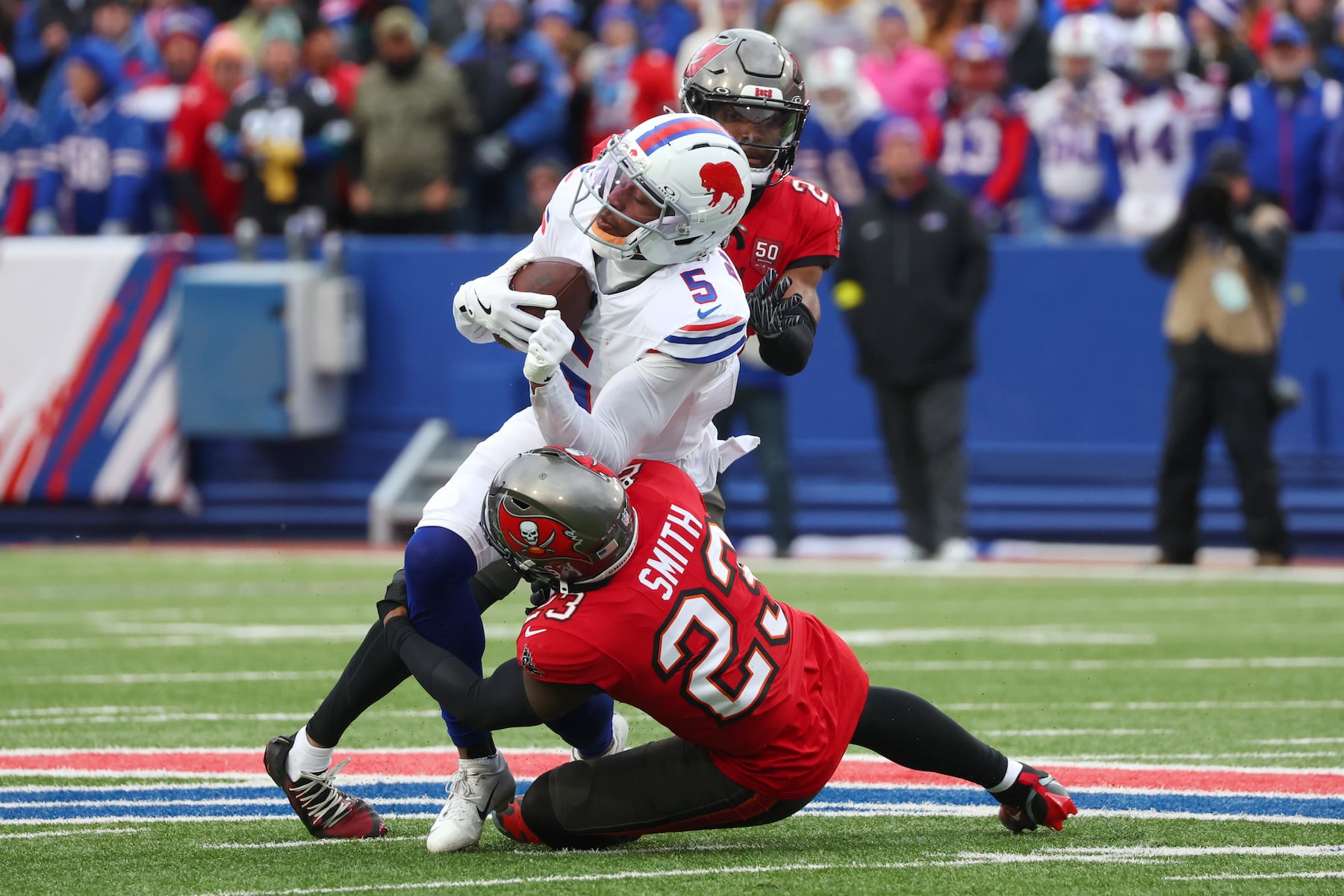 Tampa Bay Buccaneers safety Tykee Smith (23) tackles Buffalo Bills wide receiver Joshua Palmer (5) after a catch during the first half of an NFL football game, Sunday, Nov. 16, 2025, in Orchard Park, N.Y. (AP Photo/Jeffrey T. Barnes)