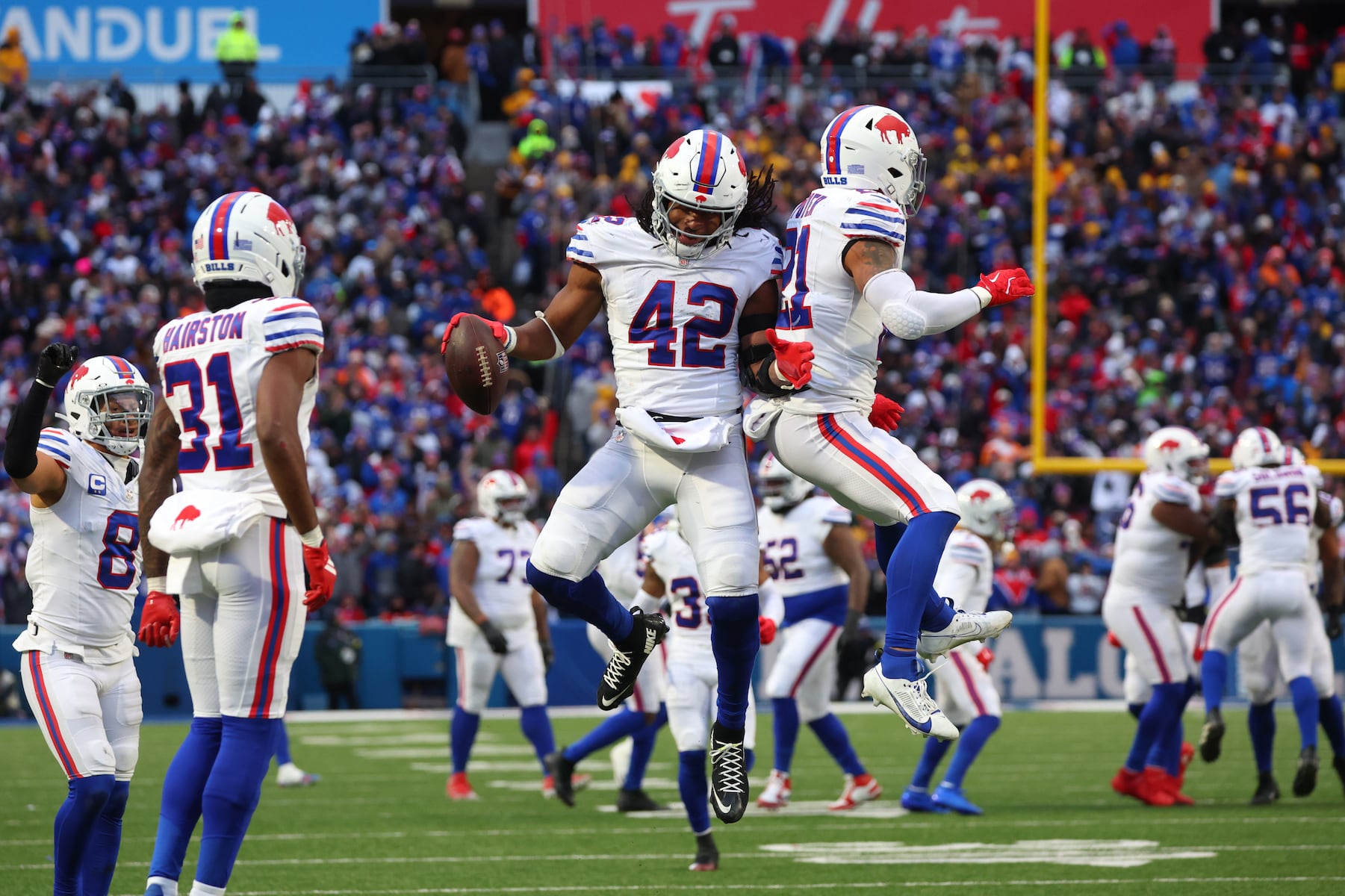 Buffalo Bills linebacker Dorian Williams (42) celebrates with safety Jordan Poyer after a fumble recovery against the Tampa Bay Buccaneers during the second half of an NFL football game, Sunday, Nov. 16, 2025, in Orchard Park, N.Y. (AP Photo/Jeffrey T. Barnes)