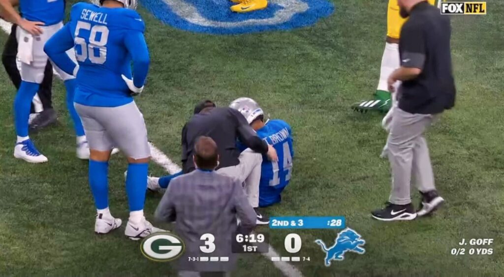 Amon-Ra St. Brown sitting after injury