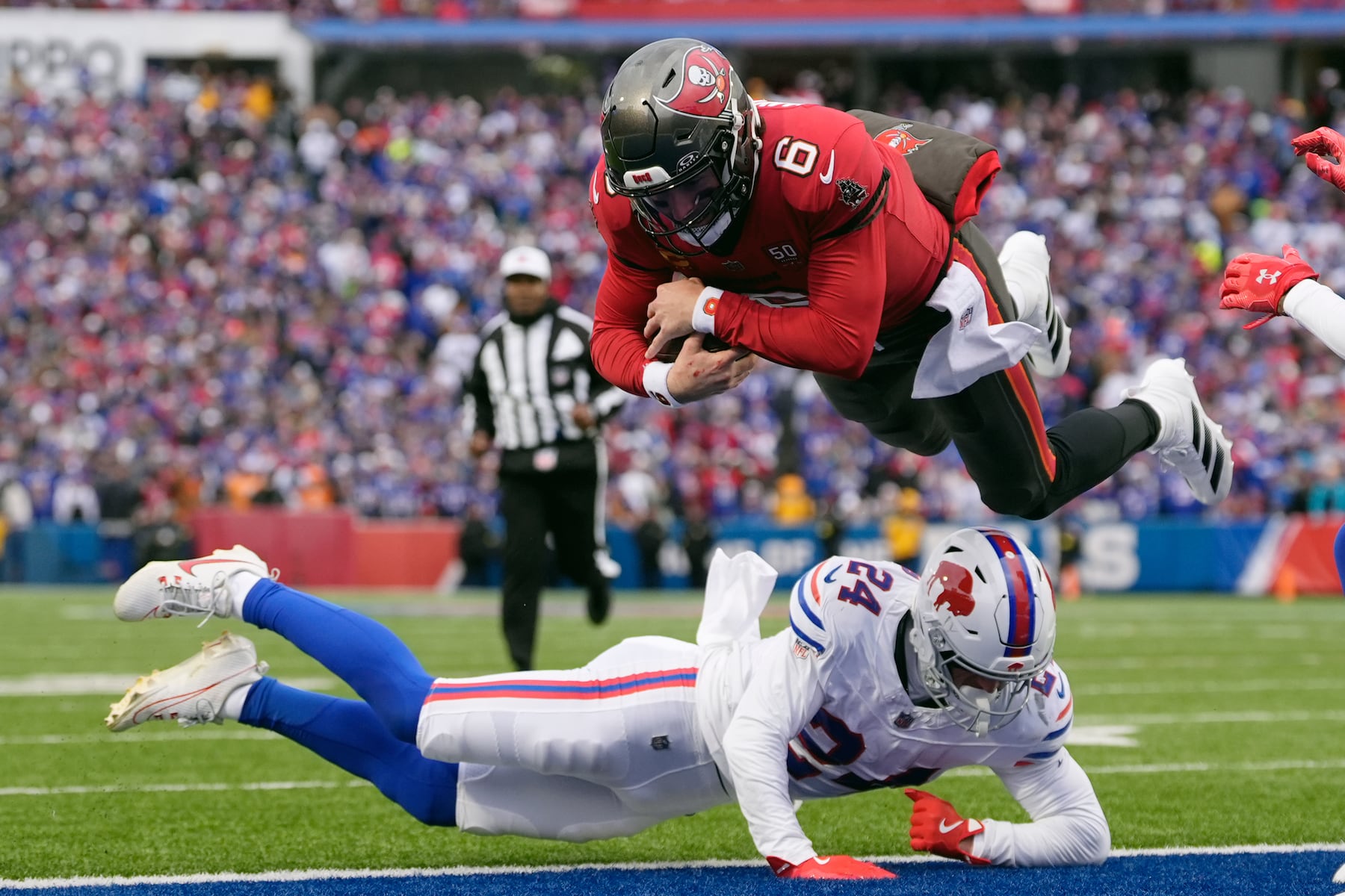 Tampa Bay Buccaneers quarterback Baker Mayfield (6) runs for a touchdown against Buffalo Bills safety Cole Bishop (24) during the first half of an NFL football game, Sunday, Nov. 16, 2025, in Orchard Park, N.Y. (AP Photo/Carolyn Kaster)