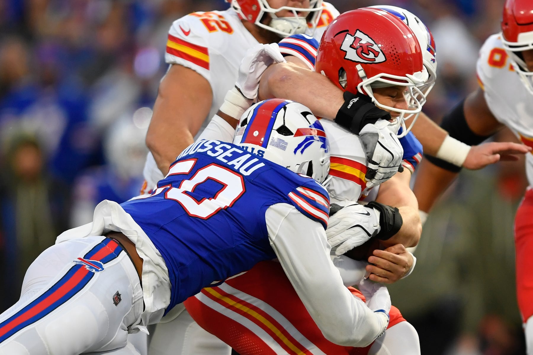Kansas City Chiefs quarterback Patrick Mahomes, right, is stopped by Buffalo Bills defensive end Greg Rousseau, left, during the first half of an NFL football game Sunday, Nov. 2, 2025, in Orchard Park. N.Y. (AP Photo/Adrian Kraus)
