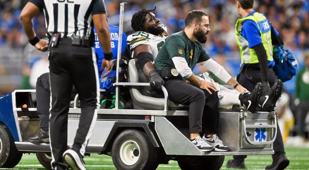 Devonte Wyatt carted off the field after suffering ankle injury.