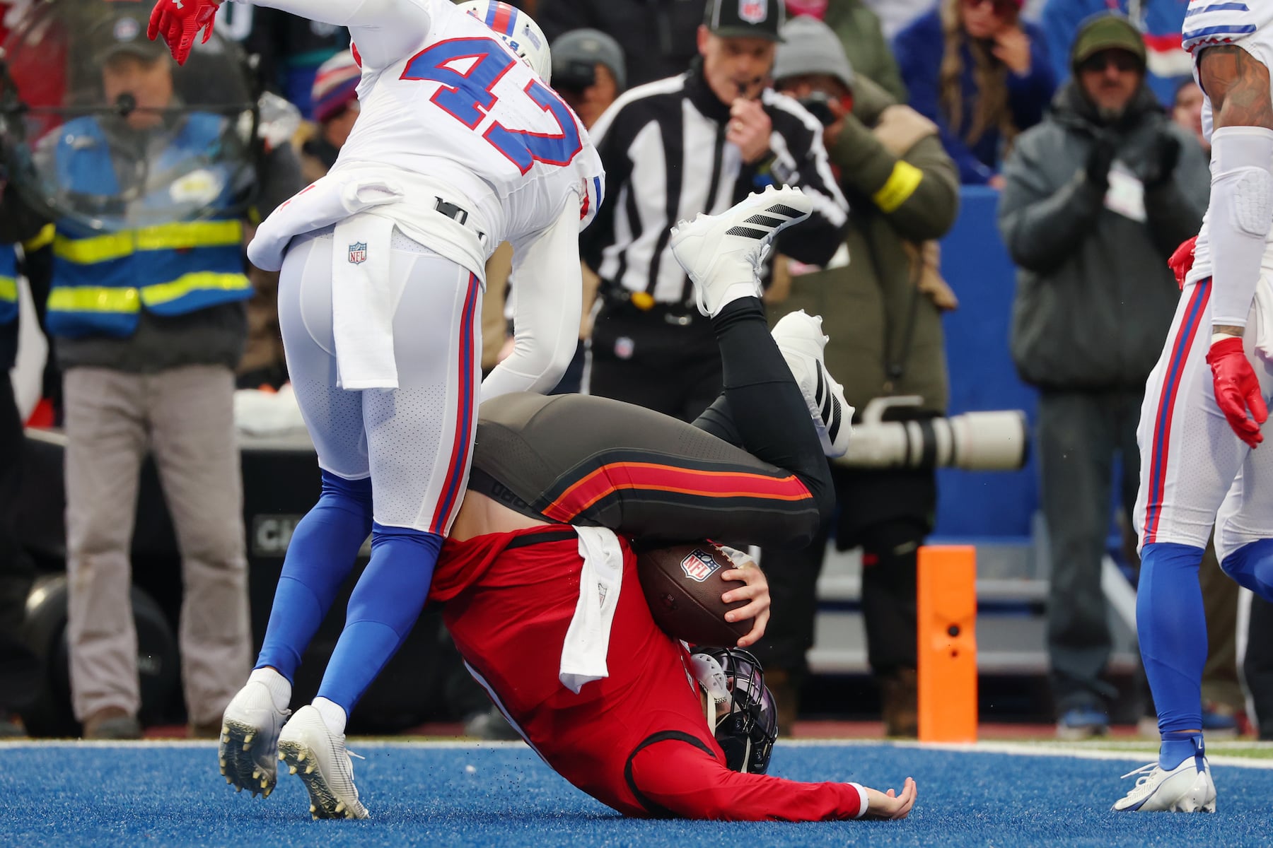 Tampa Bay Buccaneers quarterback Baker Mayfield (6) scores a touchdown against Buffalo Bills cornerback Christian Benford (47) during the first half of an NFL football game, Sunday, Nov. 16, 2025, in Orchard Park, N.Y. (AP Photo/Jeffrey T. Barnes)
