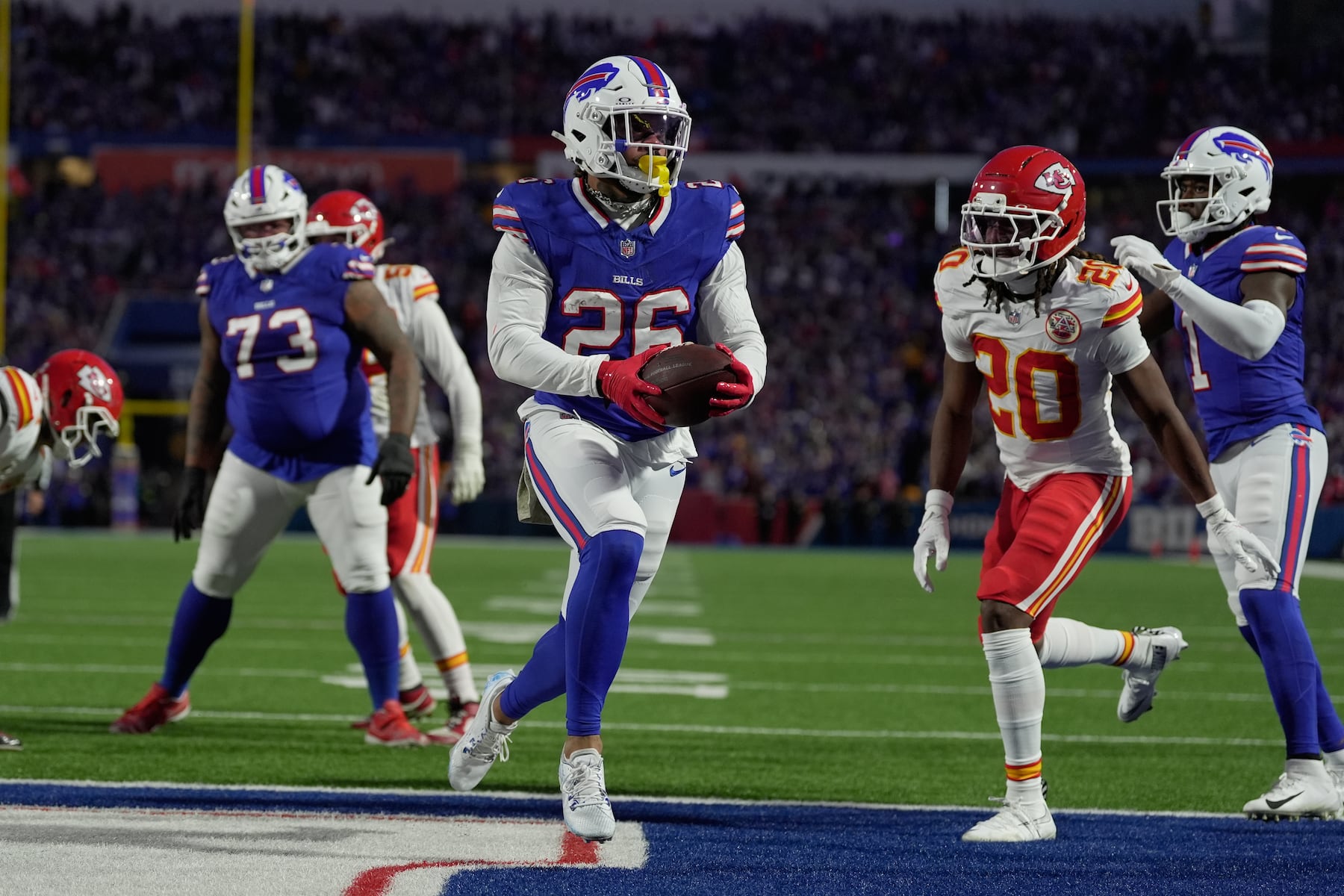 Buffalo Bills running back Ty Johnson (26) scores past Kansas City Chiefs defensive back Nohl Williams (20) during the first half of an NFL football game Sunday, Nov. 2, 2025, in Orchard Park. N.Y. (AP Photo/Sue Ogrocki)