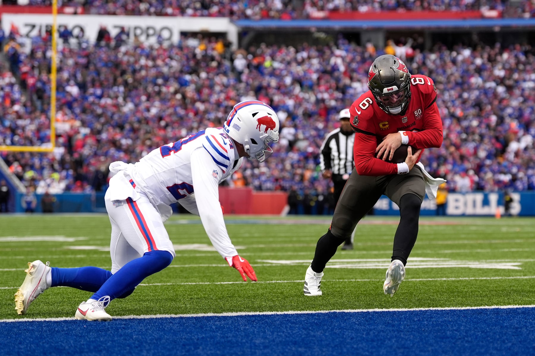Tampa Bay Buccaneers quarterback Baker Mayfield (6) runs for a touchdown against Buffalo Bills safety Cole Bishop (24) during the first half of an NFL football game, Sunday, Nov. 16, 2025, in Orchard Park, N.Y. (AP Photo/Carolyn Kaster)
