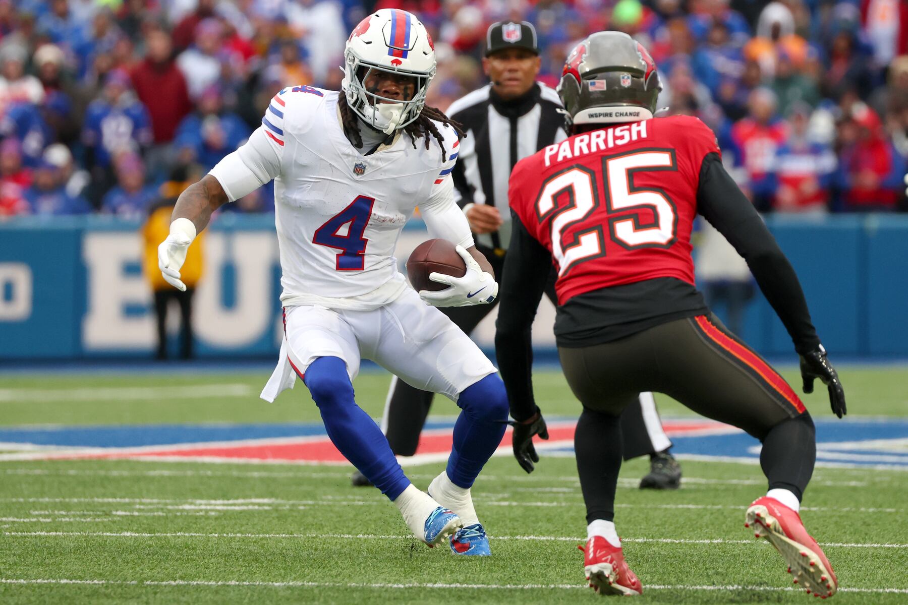 Buffalo Bills running back James Cook III (4) runs against Tampa Bay Buccaneers cornerback Jacob Parrish (25) during the first half of an NFL football game, Sunday, Nov. 16, 2025, in Orchard Park, N.Y. (AP Photo/Jeffrey T. Barnes)