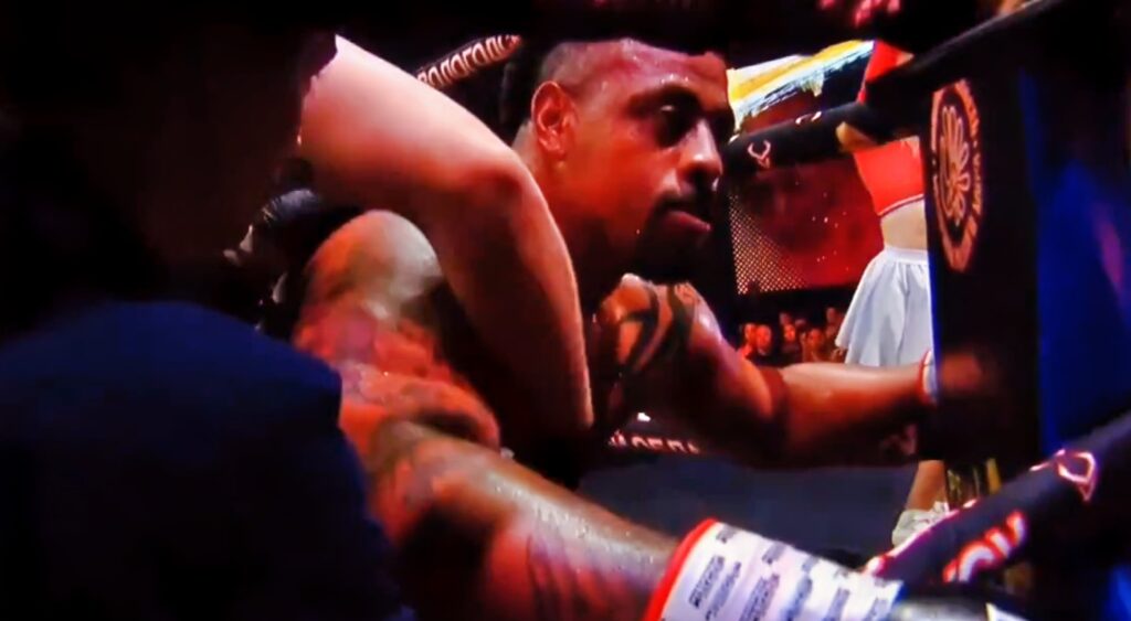 Greg Hardy on his knees in a boxing ring