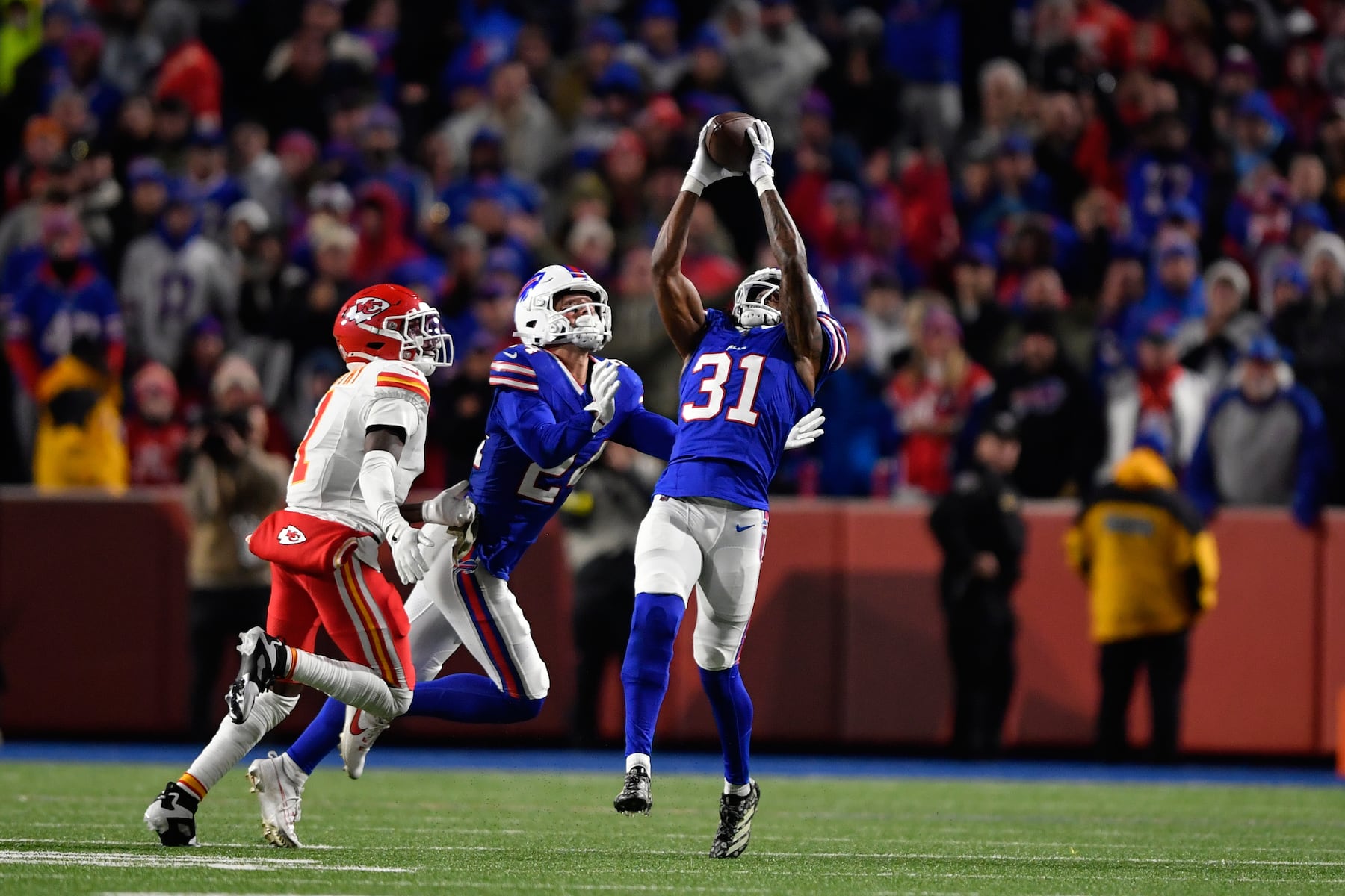 Buffalo Bills cornerback Maxwell Hairston (31) intercepts a pass intended for Kansas City Chiefs wide receiver Xavier Worthy, left, as Bills safety Cole Bishop, center, watches during the second half of an NFL football game Sunday, Nov. 2, 2025, in Orchard Park. N.Y. (AP Photo/Adrian Kraus)