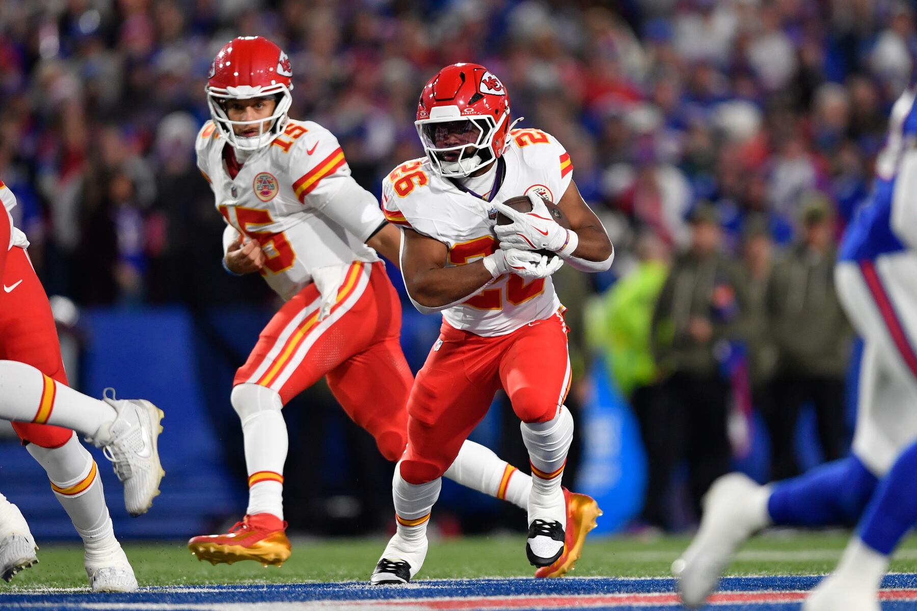 Kansas City Chiefs running back Clyde Edwards-Helaire (26) takes a handoff from quarterback Patrick Mahomes during the first half of an NFL football game against the Buffalo Bills Sunday, Nov. 2, 2025, in Orchard Park. N.Y. (AP Photo/Adrian Kraus)