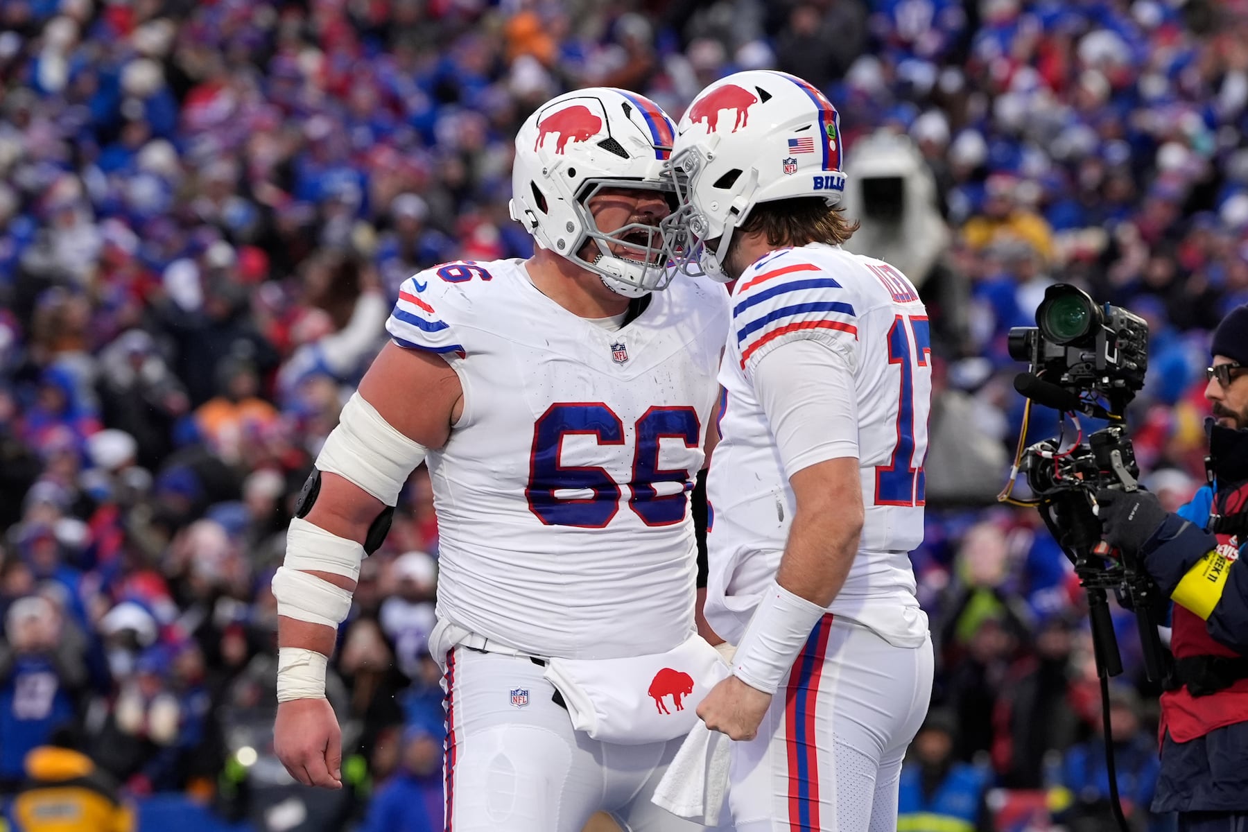 Buffalo Bills quarterback Josh Allen, right, celebrates with guard Connor McGovern (66) after scoring a touchdown during the second half of an NFL football game, Sunday, Nov. 16, 2025, in Orchard Park, N.Y. (AP Photo/Carolyn Kaster)