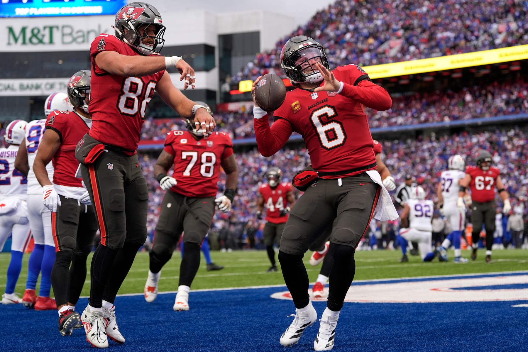 Tampa Bay Buccaneers quarterback Baker Mayfield (6) celebrates after scoring a touchdown against the Buffalo Bills during the first half of an NFL football game, Sunday, Nov. 16, 2025, in Orchard Park, N.Y. (AP Photo/Carolyn Kaster)