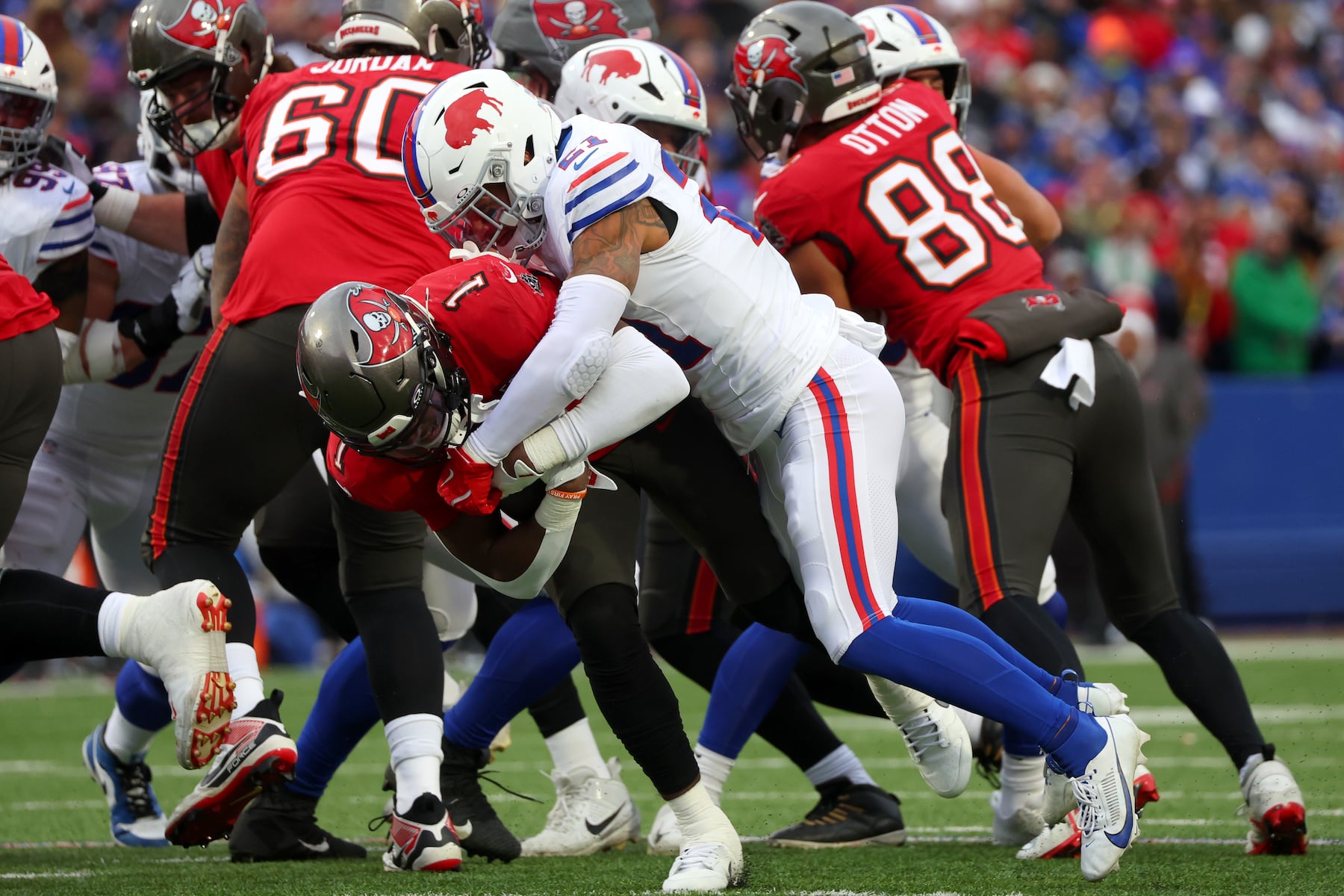 Buffalo Bills safety Jordan Poyer (21) tackles Tampa Bay Buccaneers running back Rachaad White (1) during the first half of an NFL football game, Sunday, Nov. 16, 2025, in Orchard Park, N.Y. (AP Photo/Jeffrey T. Barnes)