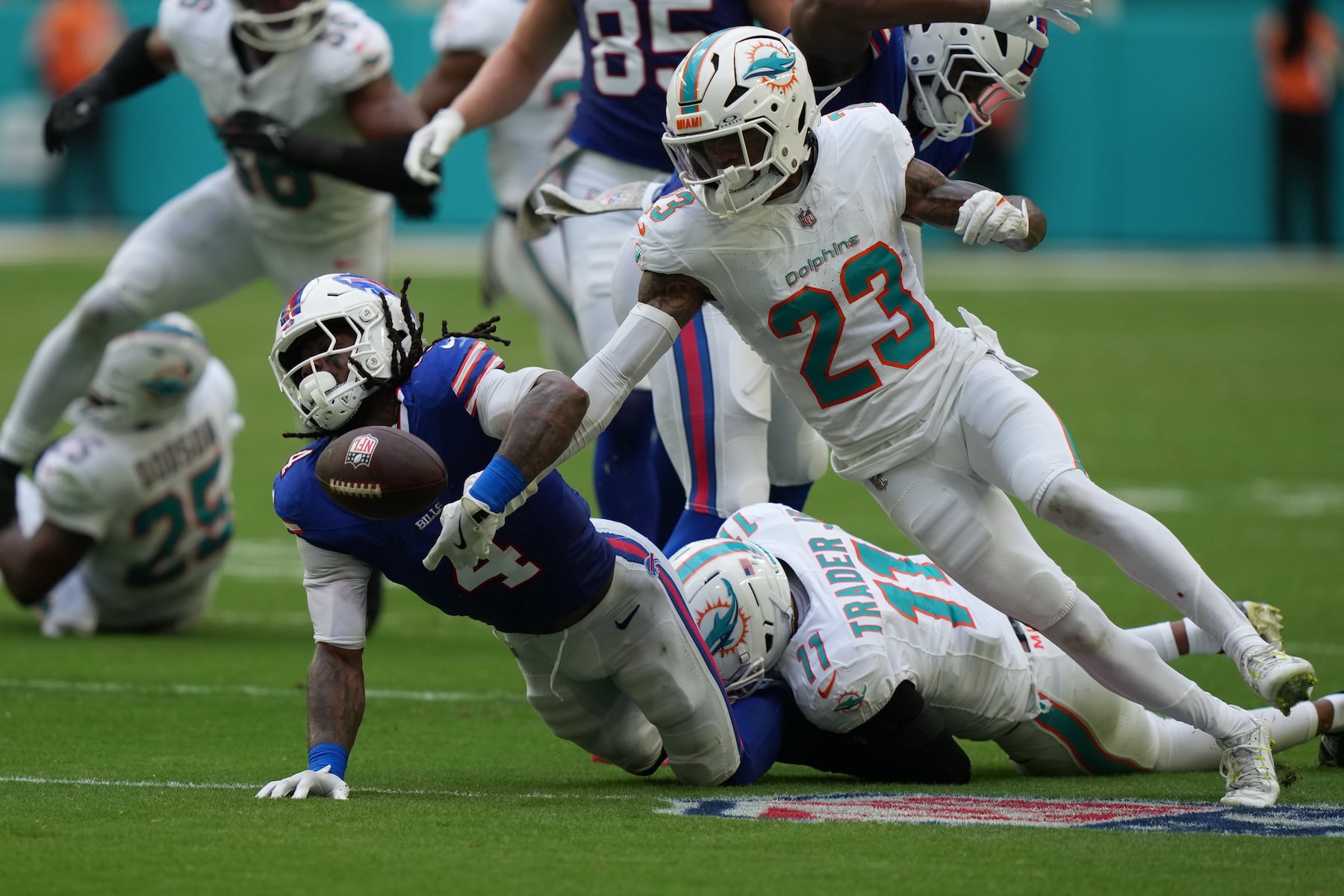 Buffalo Bills' James Cook (4) fumbles against Miami Dolphins' Jack Jones (23) during the first half of an NFL football game, Sunday, Nov. 9, 2025, in Miami Gardens, Fla. (AP Photo/Lynne Sladky)