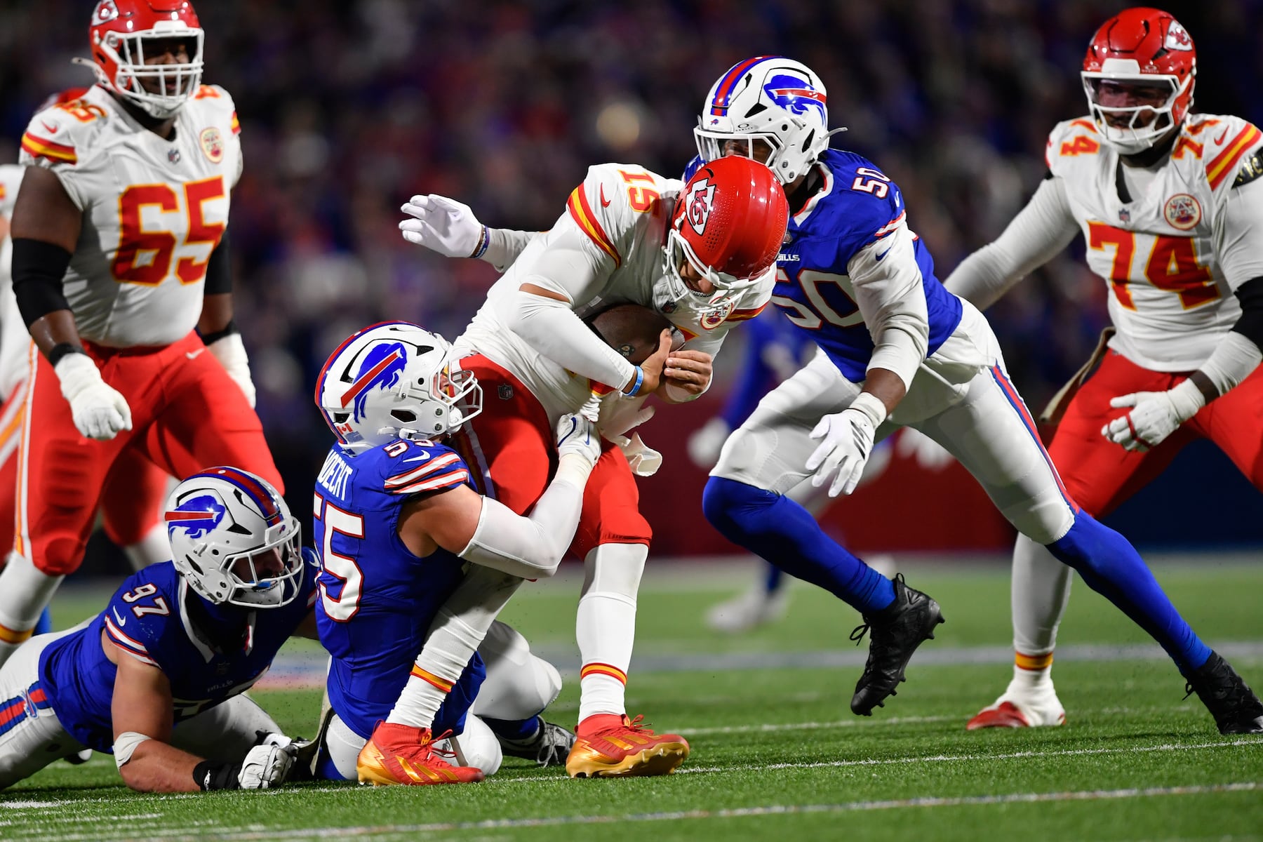 Kansas City Chiefs quarterback Patrick Mahomes (15) is sacked by Buffalo Bills defensive end Michael Hoecht (55) and defensive end Greg Rousseau (50) during the second half of an NFL football game Sunday, Nov. 2, 2025, in Orchard Park. N.Y. (AP Photo/Adrian Kraus)