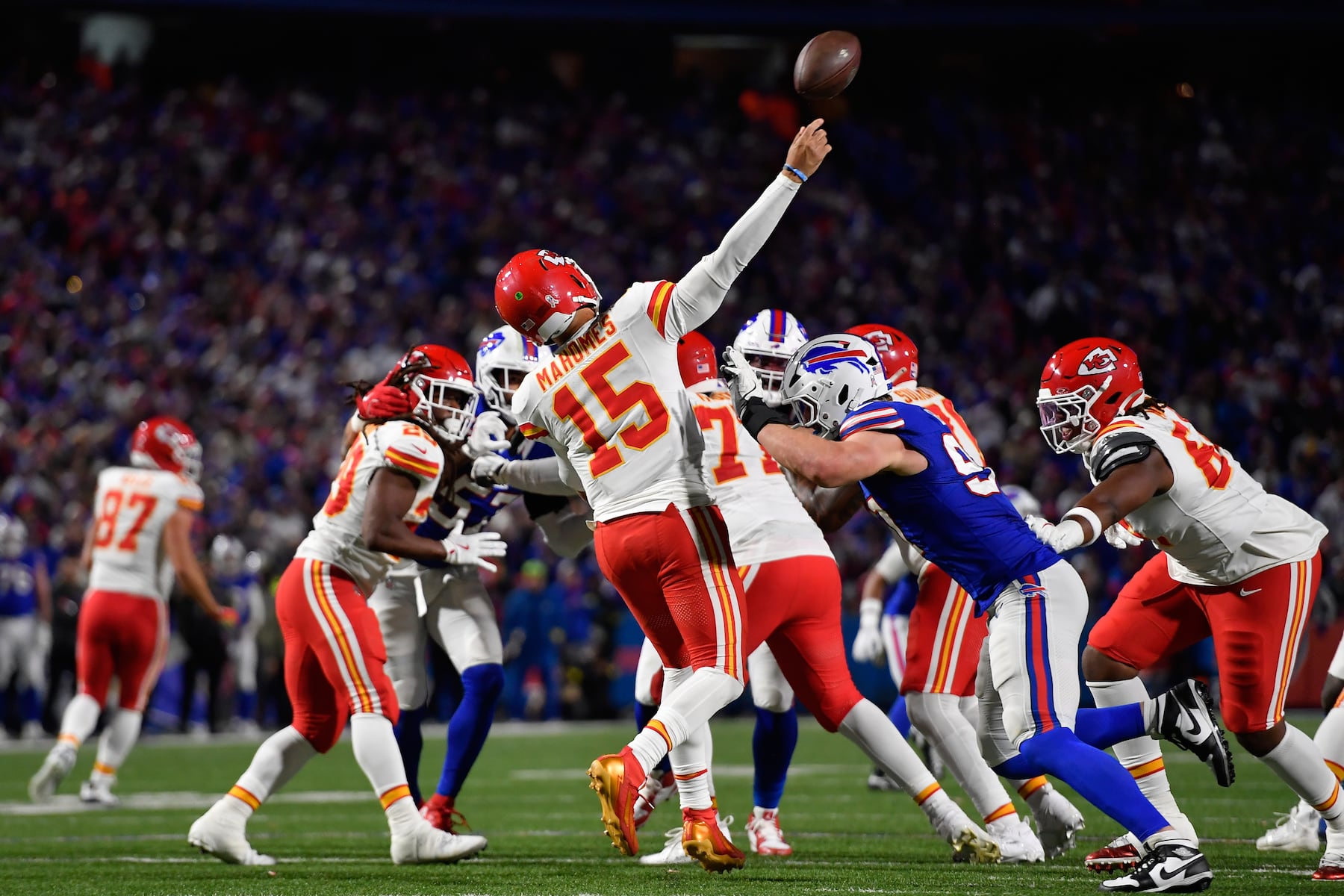 Kansas City Chiefs quarterback Patrick Mahomes (15) is hit by Buffalo Bills defensive end Joey Bosa while throwing a pass intercepted by Bills cornerback Maxwell Hairston during the second half of an NFL football game Sunday, Nov. 2, 2025, in Orchard Park. N.Y. (AP Photo/Adrian Kraus)