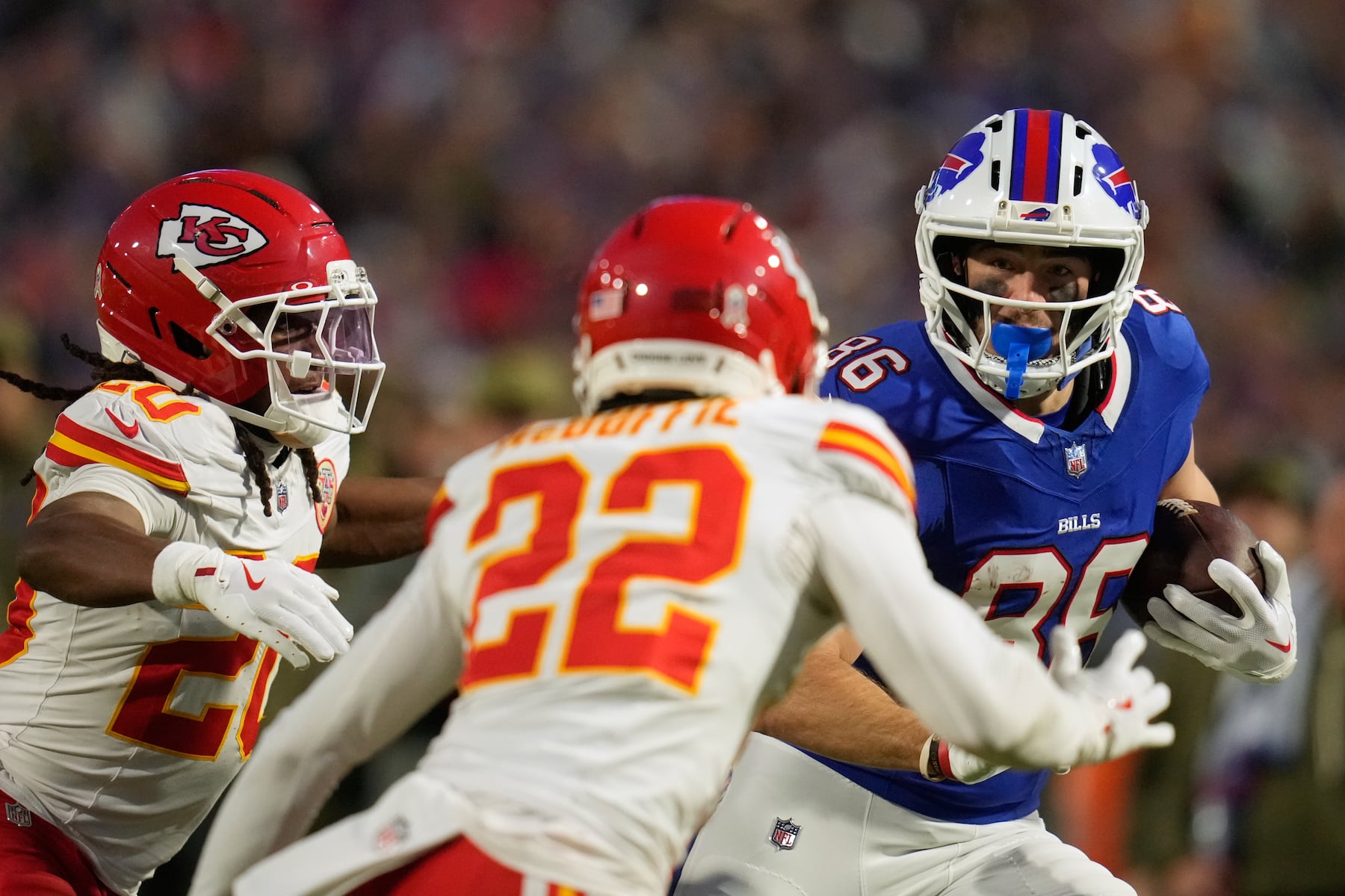 Buffalo Bills tight end Dalton Kincaid (86) runs with the ball after making a catch as Kansas City Chiefs cornerback Trent McDuffie (22) and defensive back Nohl Williams (20) defend during the first half of an NFL football game Sunday, Nov. 2, 2025, in Orchard Park. N.Y. (AP Photo/Sue Ogrocki)