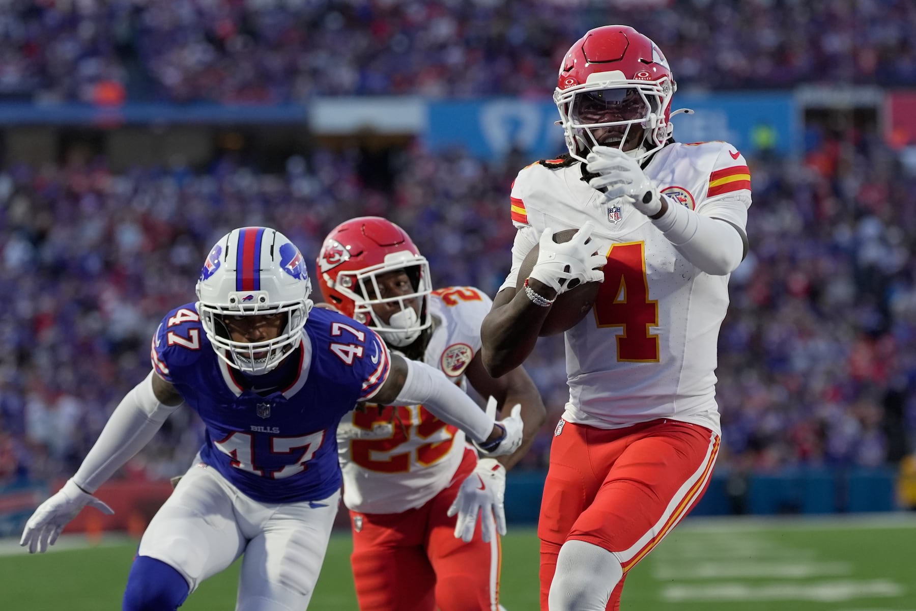 Kansas City Chiefs wide receiver Rashee Rice (4) scores past Buffalo Bills cornerback Christian Benford (47) during the first half of an NFL football game Sunday, Nov. 2, 2025, in Orchard Park. N.Y. (AP Photo/Sue Ogrocki)