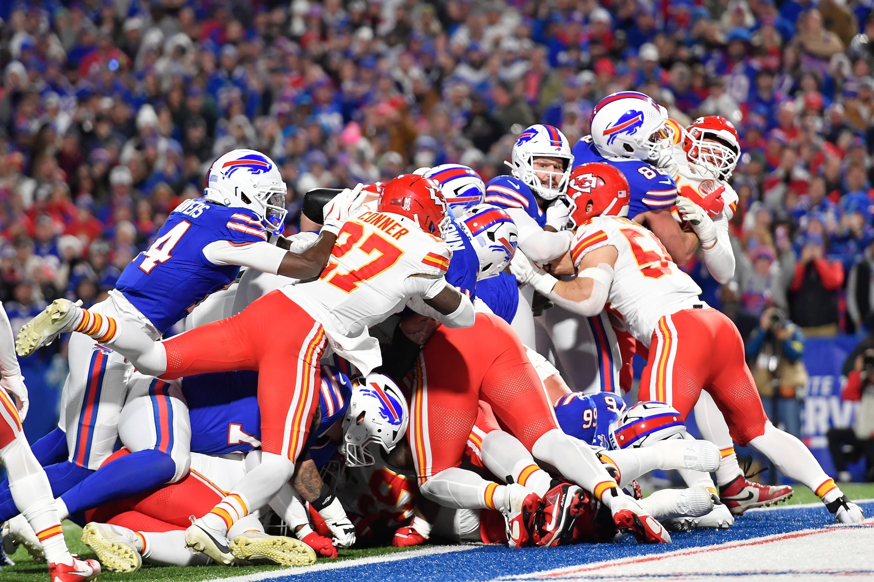 Buffalo Bills quarterback Josh Allen (17) scores as Kansas City Chiefs linebacker Leo Chenal and defensive back Chamarri Conner (27) defend during the first half of an NFL football game Sunday, Nov. 2, 2025, in Orchard Park. N.Y. (AP Photo/Adrian Kraus)