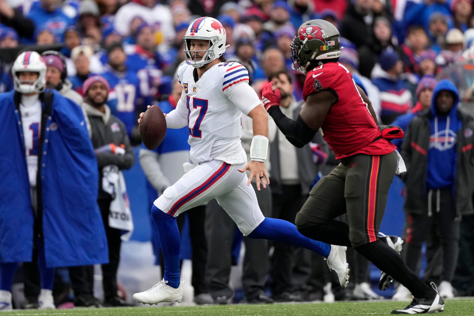 Buffalo Bills quarterback Josh Allen (17) runs against Tampa Bay Buccaneers linebacker Yaya Diaby (0) during the first half of an NFL football game, Sunday, Nov. 16, 2025, in Orchard Park, N.Y. (AP Photo/Carolyn Kaster)