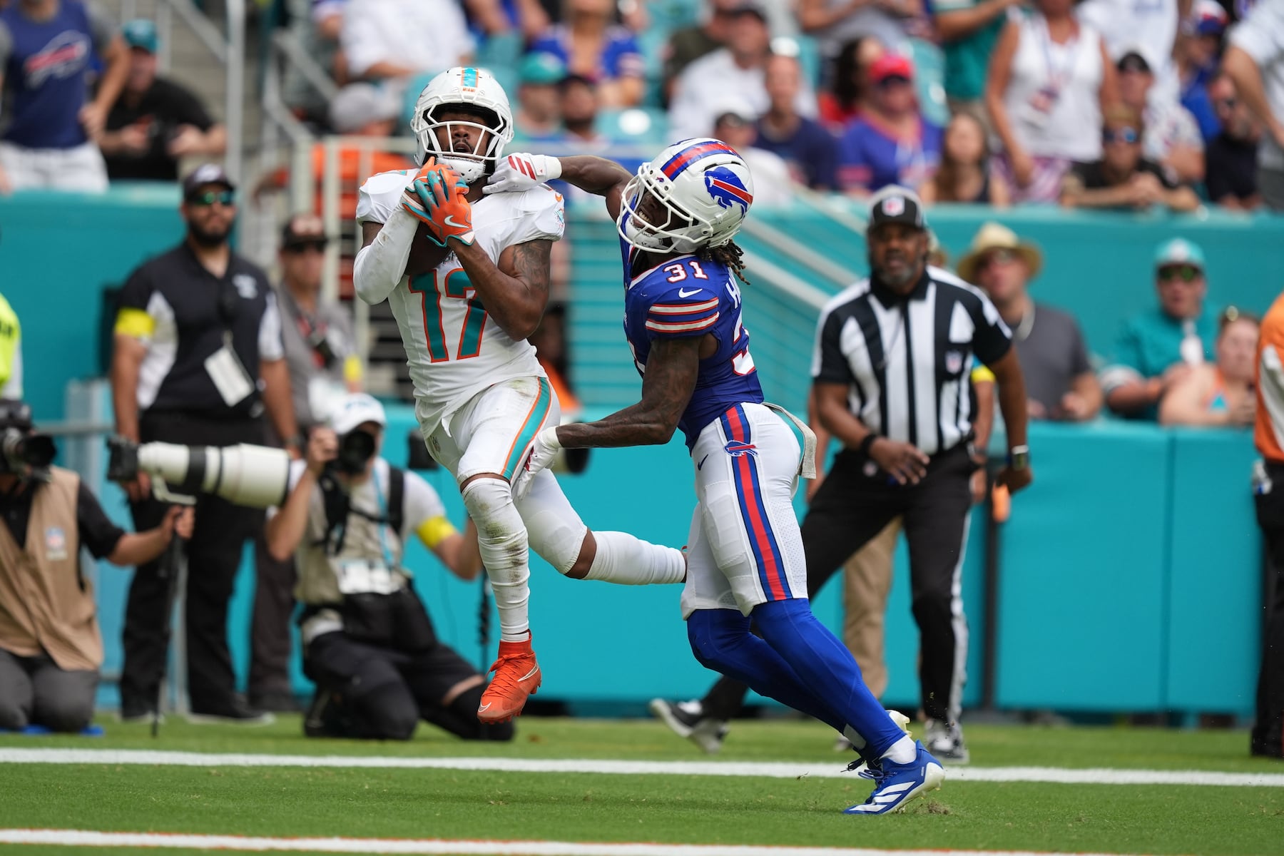 Miami Dolphins' Jaylen Waddle (17) makes a catch against Buffalo Bills' Maxwell Hairston (31) during the first half of an NFL football game, Sunday, Nov. 9, 2025, in Miami Gardens, Fla. (AP Photo/Rebecca Blackwell)