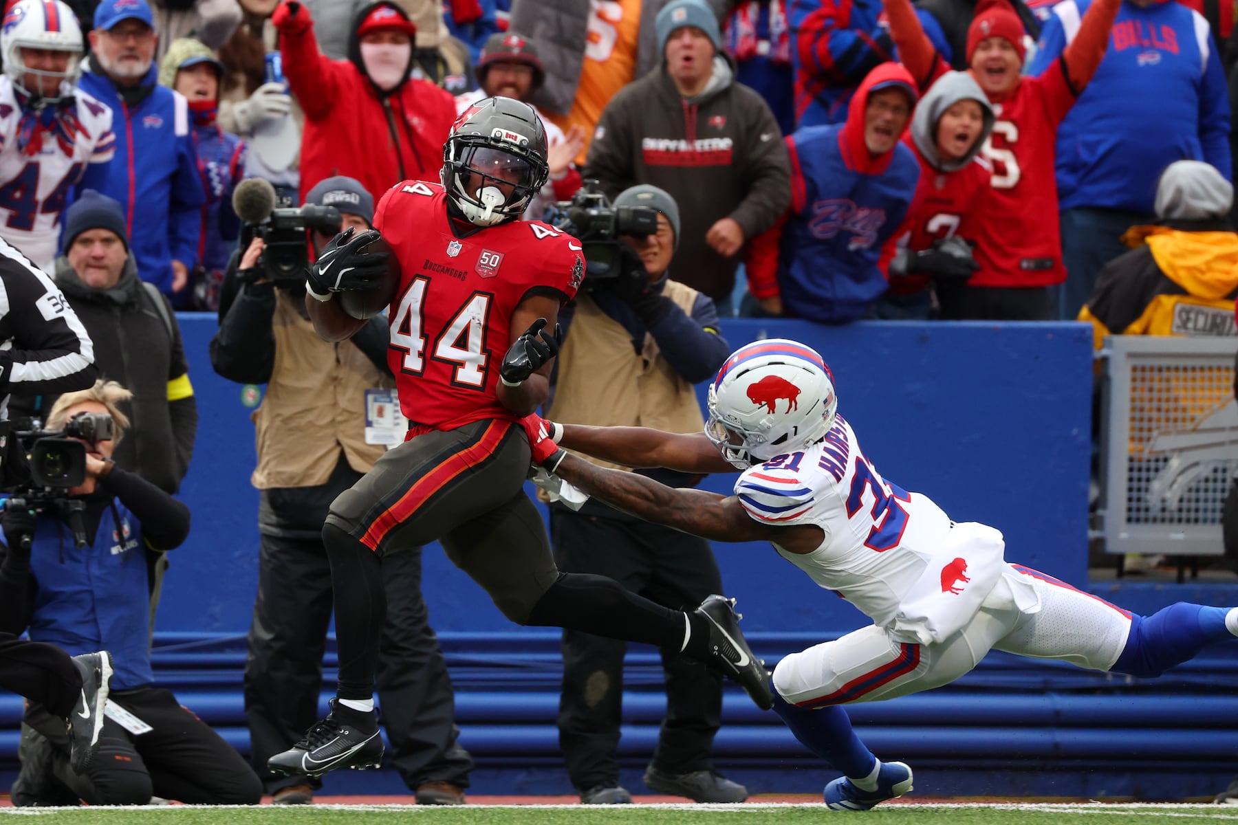 Tampa Bay Buccaneers running back Sean Tucker (44) runs for a touchdown against Buffalo Bills cornerback Maxwell Hairston (31) during the first half of an NFL football game, Sunday, Nov. 16, 2025, in Orchard Park, N.Y. (AP Photo/Jeffrey T. Barnes)
