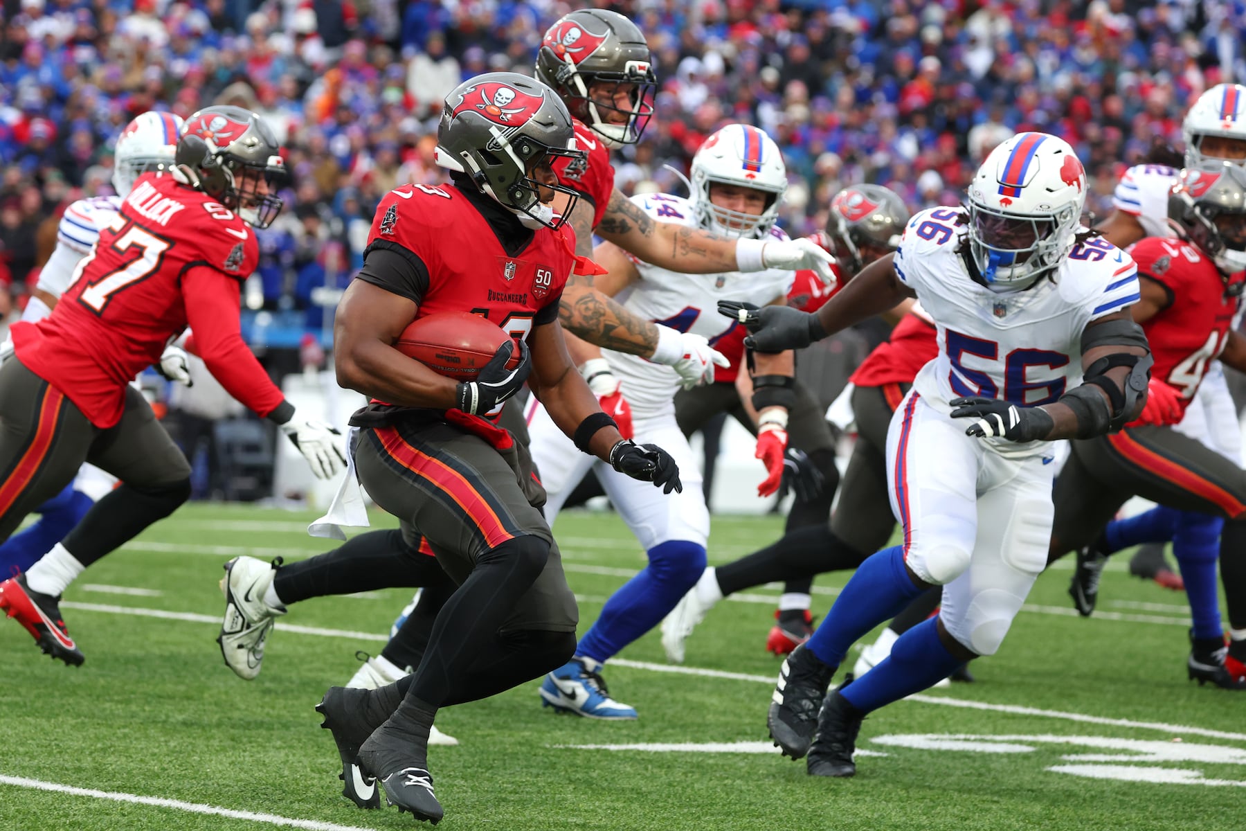 Tampa Bay Buccaneers wide receiver Kameron Johnson (19) runs against Buffalo Bills defensive end Javon Solomon (56) during the first half of an NFL football game, Sunday, Nov. 16, 2025, in Orchard Park, N.Y. (AP Photo/Jeffrey T. Barnes)