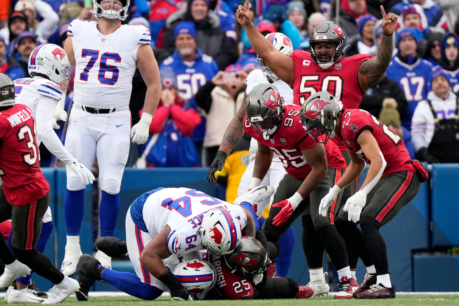Tampa Bay Buccaneers defensive tackle Vita Vea (50) reacts after cornerback Jacob Parrish (25) intercepts the ball against the Buffalo Bills during the first half of an NFL football game, Sunday, Nov. 16, 2025, in Orchard Park, N.Y. (AP Photo/Carolyn Kaster)