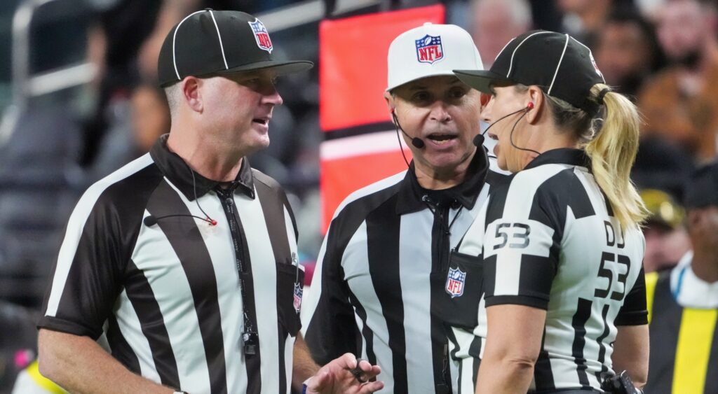 NFL refs talking during a game.)
