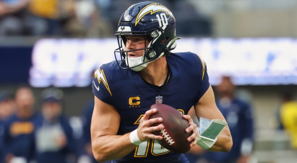 Justin Herbert looking on.