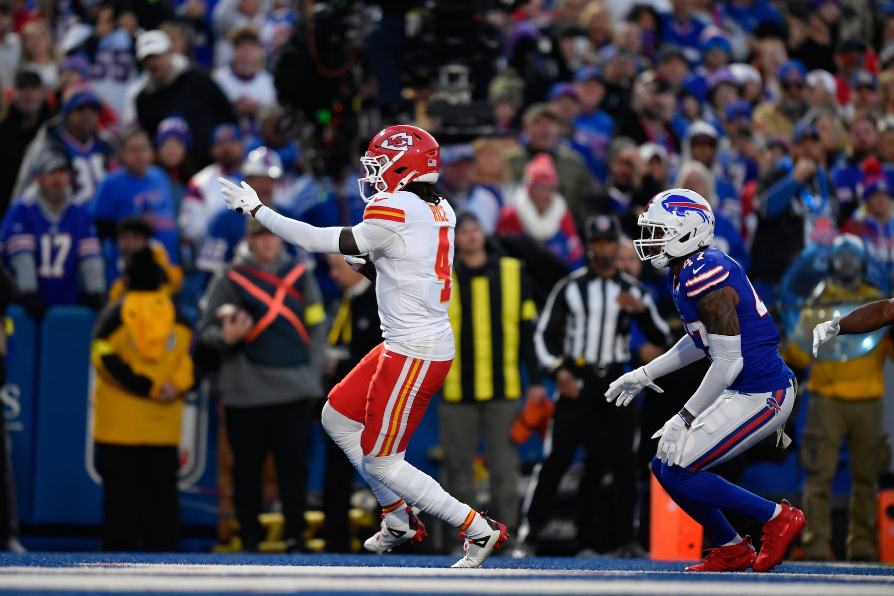 Kansas City Chiefs wide receiver Rashee Rice (4) scores past Buffalo Bills cornerback Christian Benford, right, during the first half of an NFL football game Sunday, Nov. 2, 2025, in Orchard Park. N.Y. (AP Photo/Adrian Kraus)