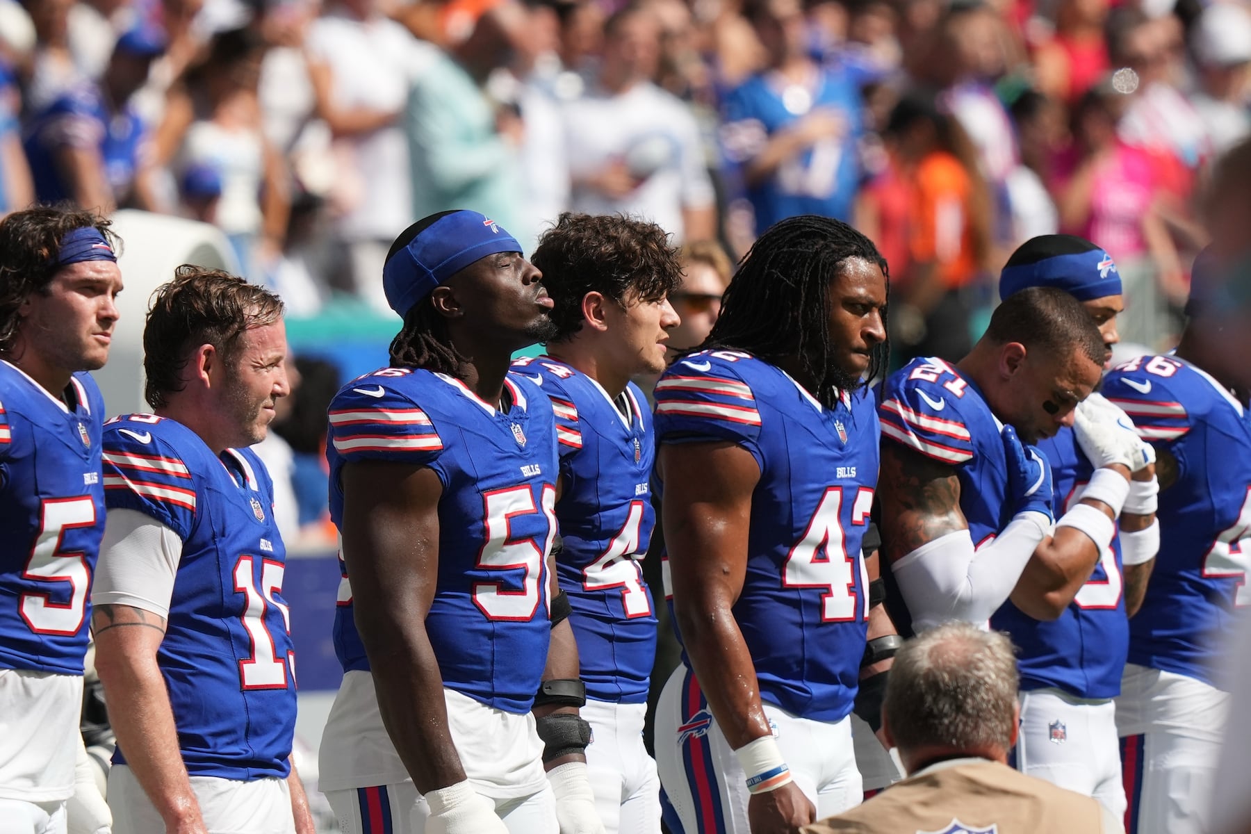 Buffalo Bills pause during a moment of silence for Dallas Cowboys' Marshawn Kneeland before an NFL football game against the Miami Dolphins, Sunday, Nov. 9, 2025, in Miami Gardens, Fla. (AP Photo/Lynne Sladky)