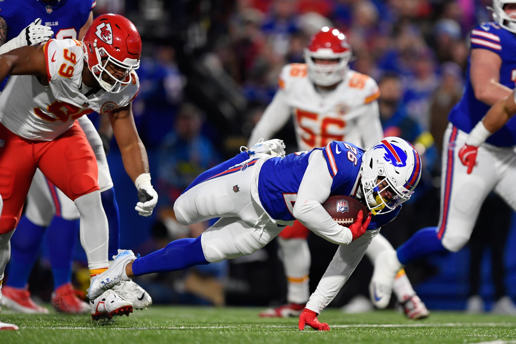 Buffalo Bills running back Ty Johnson (26) dives for yardage as Kansas City Chiefs defensive tackle Jerry Tillery (99) defends during the first half of an NFL football game Sunday, Nov. 2, 2025, in Orchard Park. N.Y. (AP Photo/Adrian Kraus)