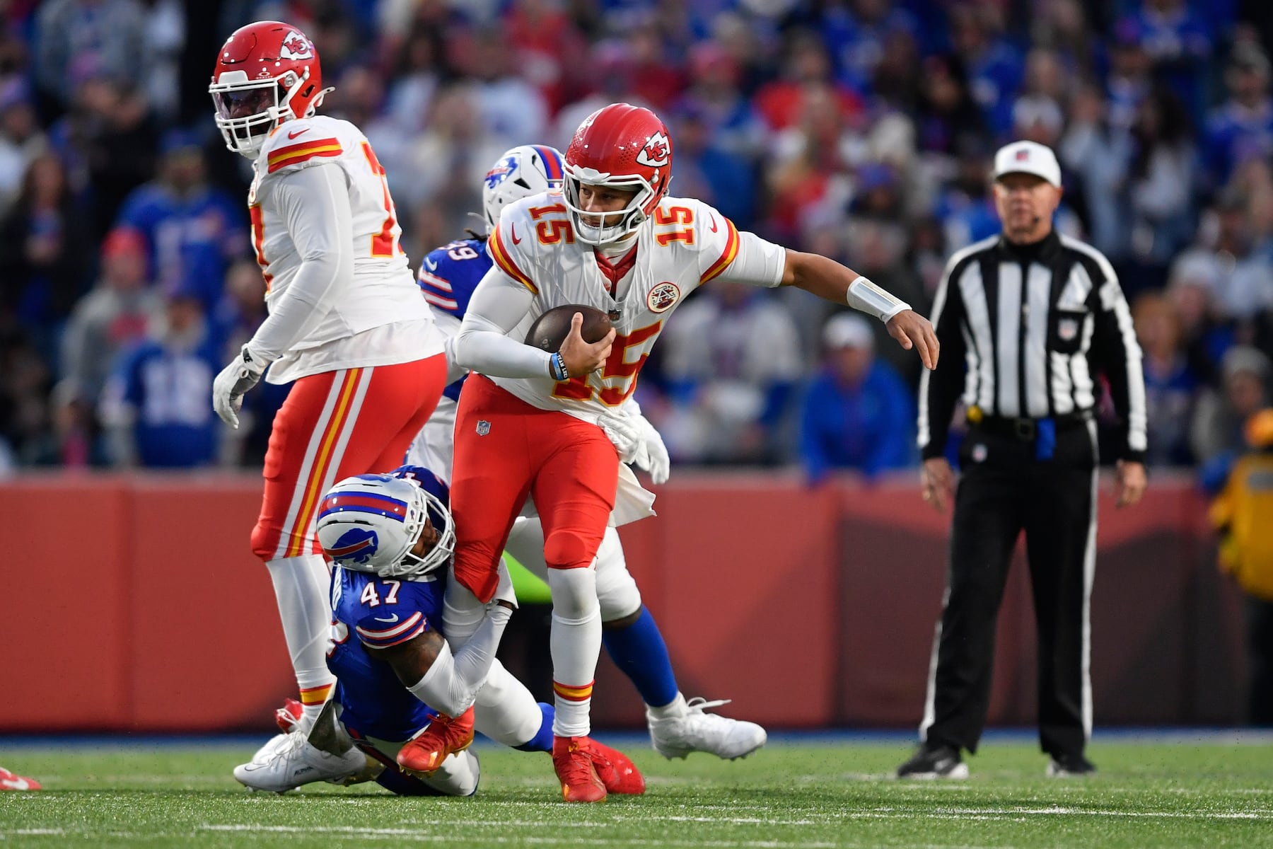 Kansas City Chiefs quarterback Patrick Mahomes (15) is sacked by Buffalo Bills cornerback Christian Benford (47) during the first half of an NFL football game Sunday, Nov. 2, 2025, in Orchard Park. N.Y. (AP Photo/Adrian Kraus)