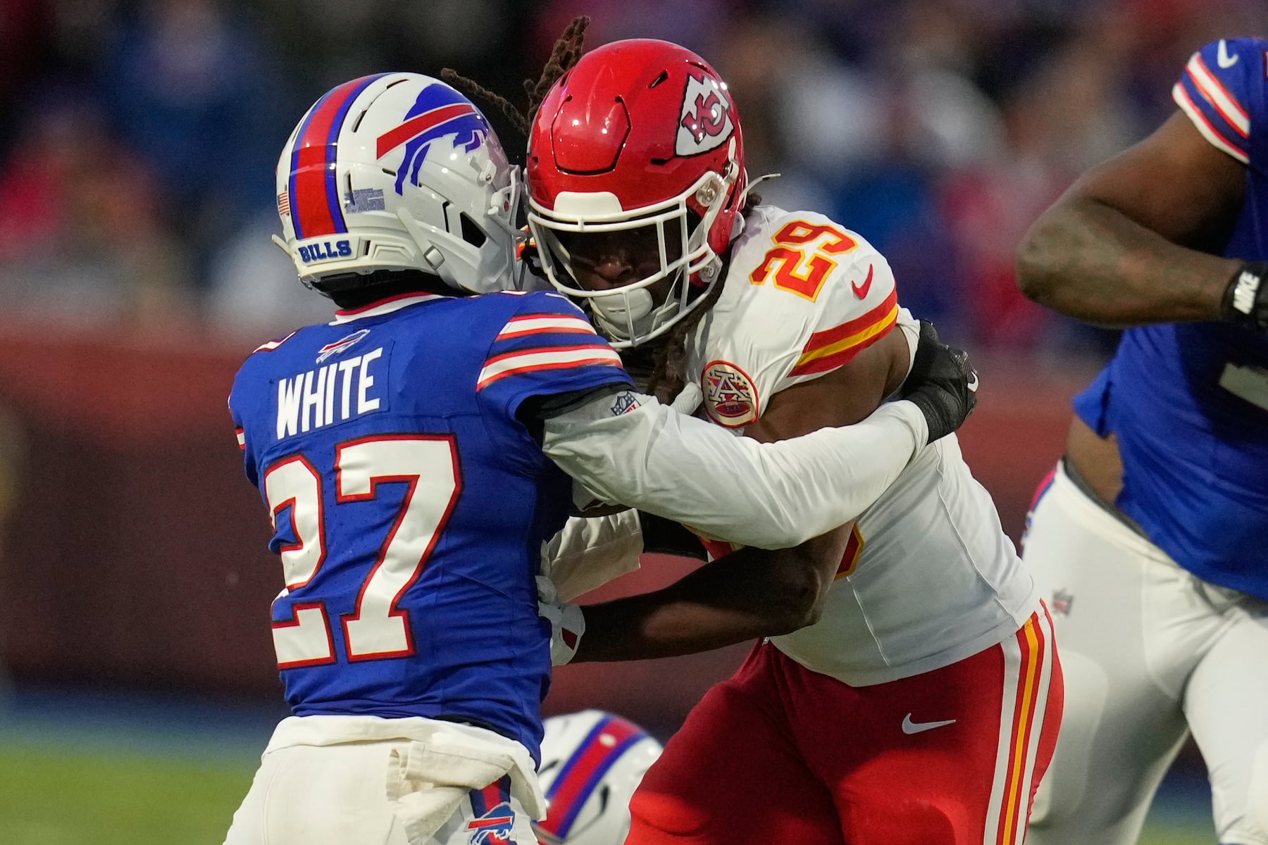 Kansas City Chiefs running back Kareem Hunt (29) runs with the ball as Buffalo Bills cornerback Tre'Davious White (27) defends during the first half of an NFL football game Sunday, Nov. 2, 2025, in Orchard Park. N.Y. (AP Photo/Sue Ogrocki)