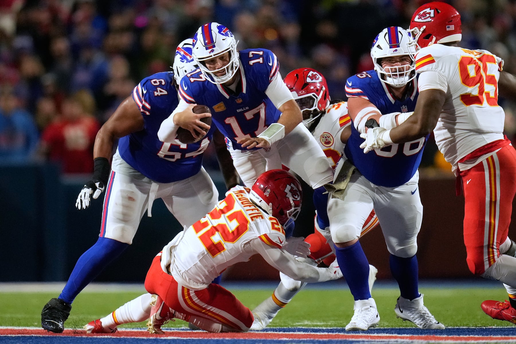 Buffalo Bills quarterback Josh Allen (17) leaps over Kansas City Chiefs cornerback Trent McDuffie (22) during the second half of an NFL football game Sunday, Nov. 2, 2025, in Orchard Park. N.Y. (AP Photo/Sue Ogrocki)