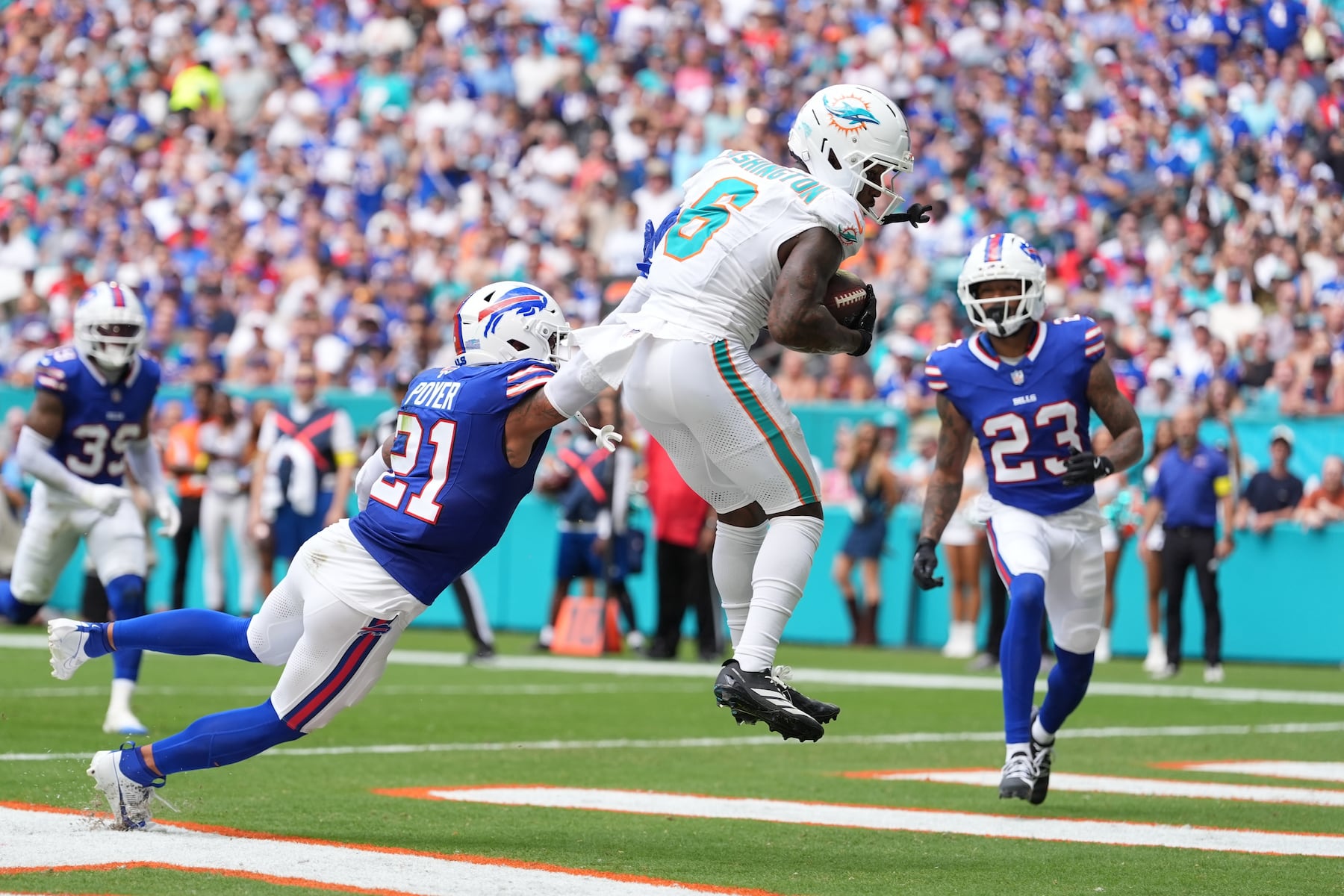 Miami Dolphins' Malik Washington (6) makes a touchdown catch against Buffalo Bills' Jordan Poyer (21) during the first half of an NFL football game, Sunday, Nov. 9, 2025, in Miami Gardens, Fla. (AP Photo/Rebecca Blackwell)