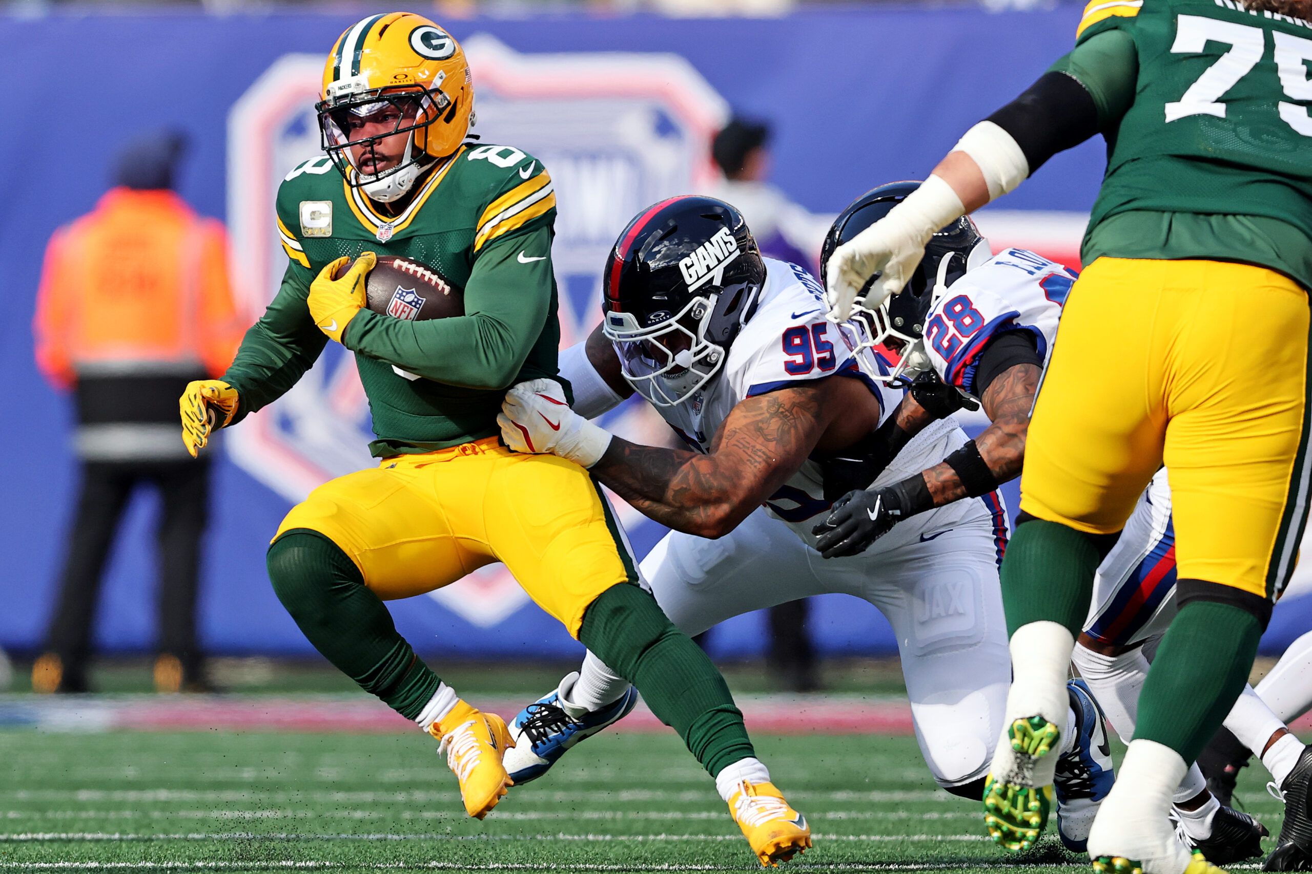 Green Bay Packers running back Josh Jacobs (8) runs the ball against New York Giants defensive tackle Roy Robertson-Harris (95) during the first quarter at MetLife Stadium.