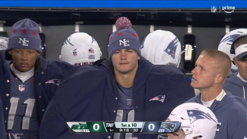 Drake Maye wearing a coat