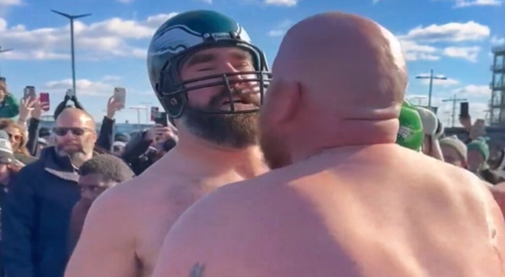 Jason Kelce talking to another man at tailgating party.