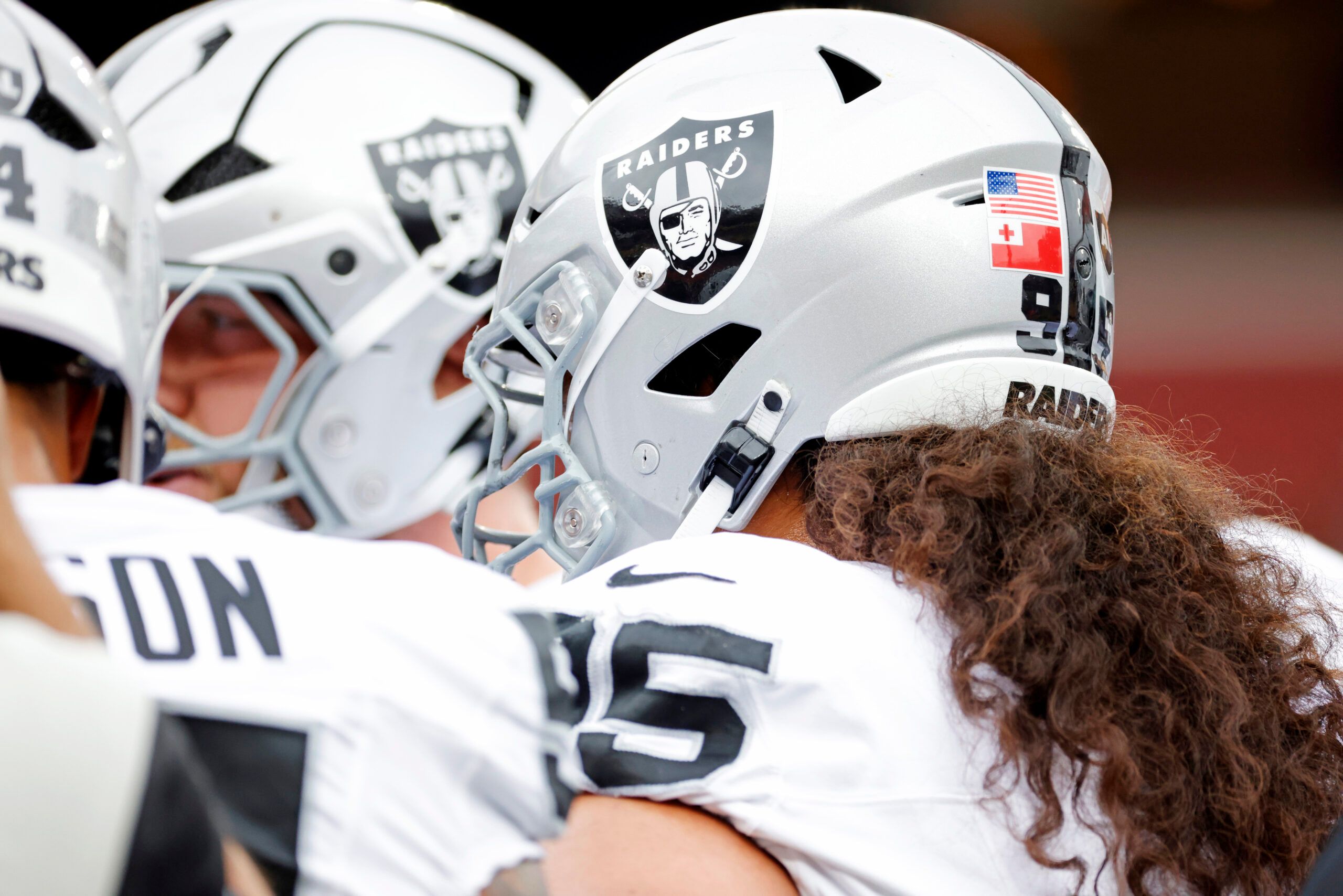 A general view of the Las Vegas Raiders helmets during a huddle before the game against the Washington Commanders at Northwest Stadium.