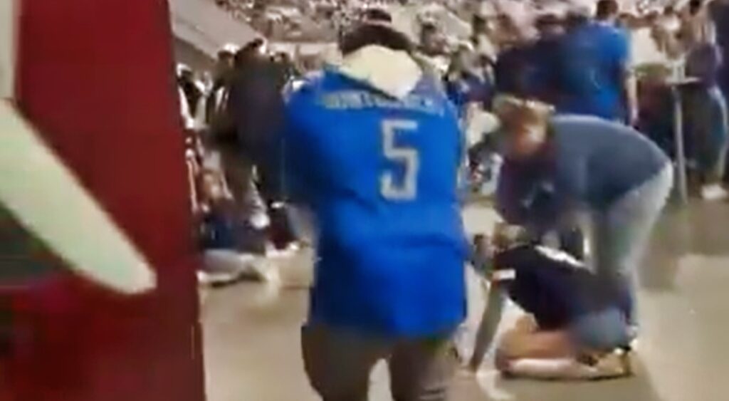Detroit Lions fan dancing while Cowboys fan vomits