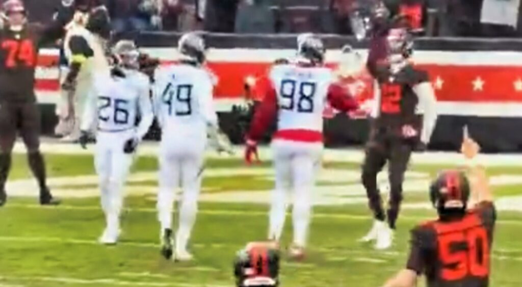 Shedeur Sanders with Titans defenders