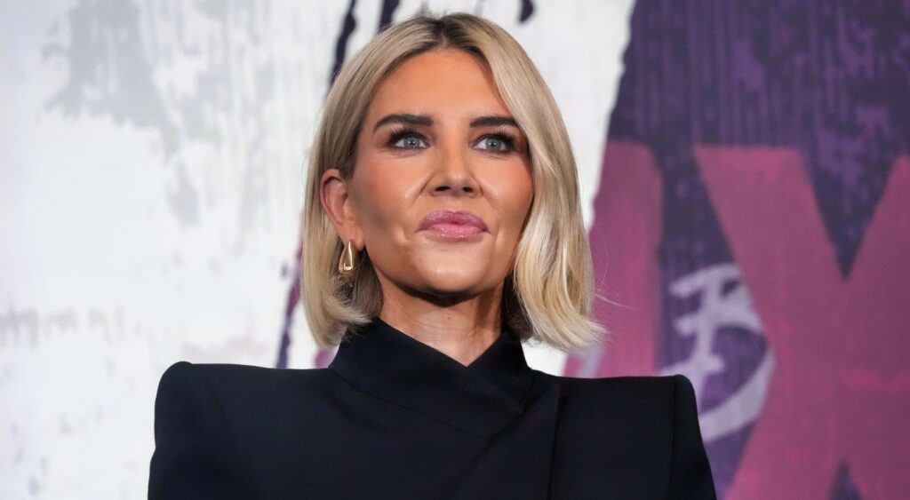 Charissa Thompson posing in black suit