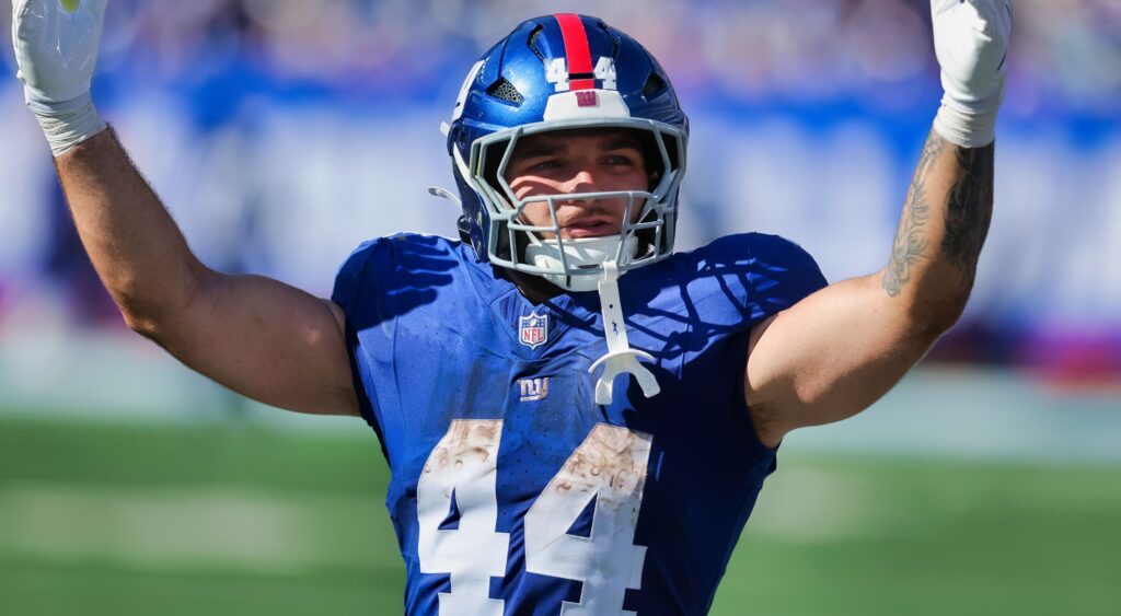 Cam Skattebo raising his arms in the air